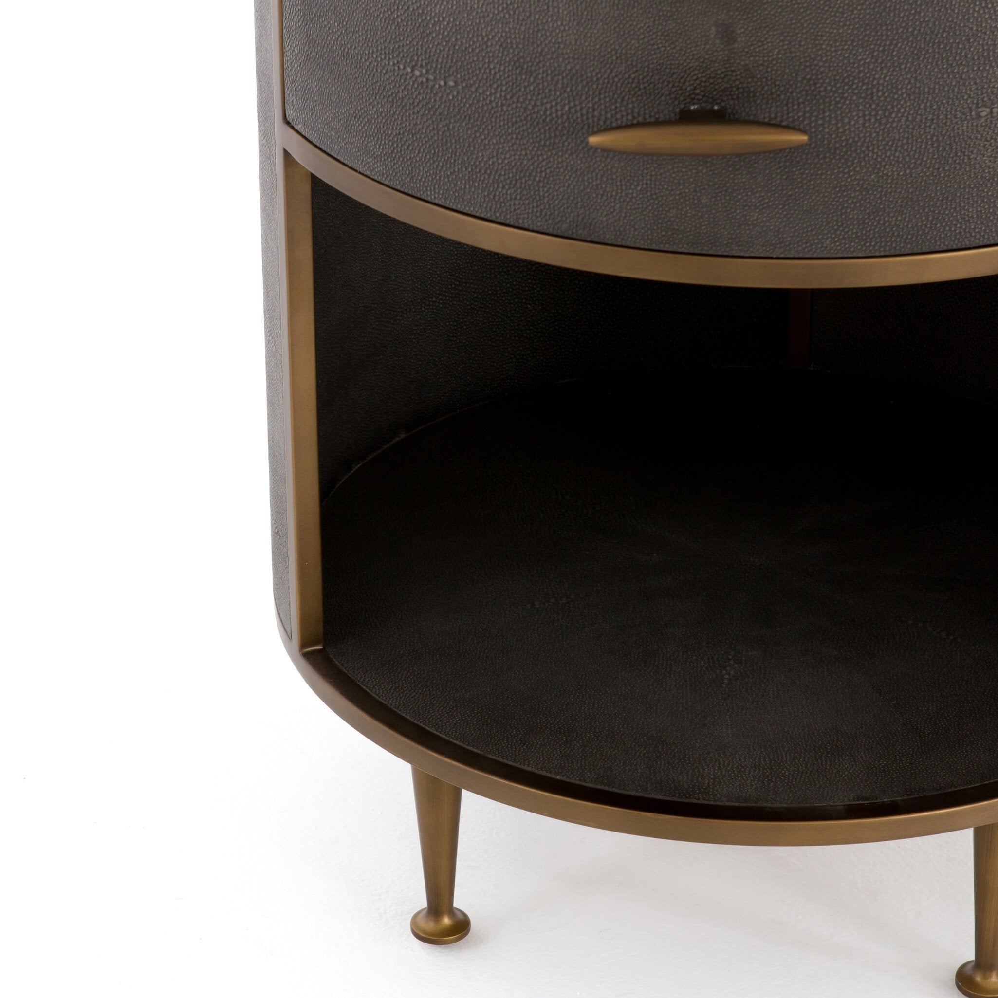 Round nightstand with a drawer and bronze legs on a white background.