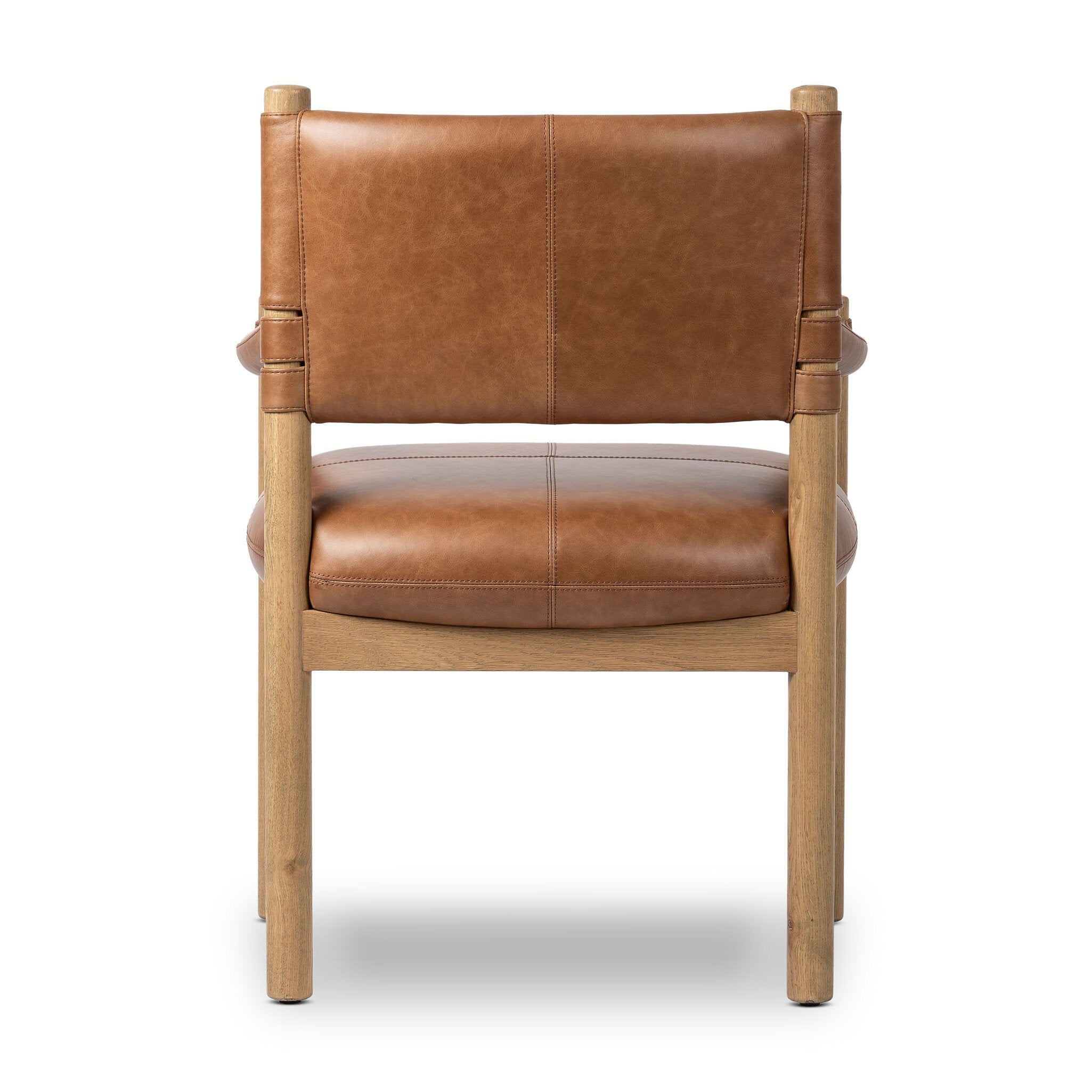 The back of a brown leather dining armchair with wooden frame on a white background.
