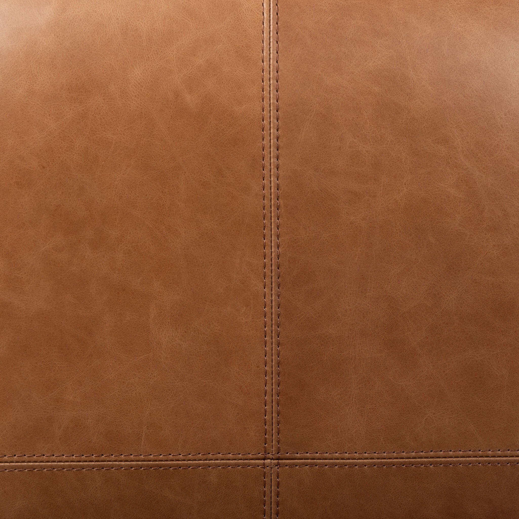 Close-up of brown leather texture with visible stitching