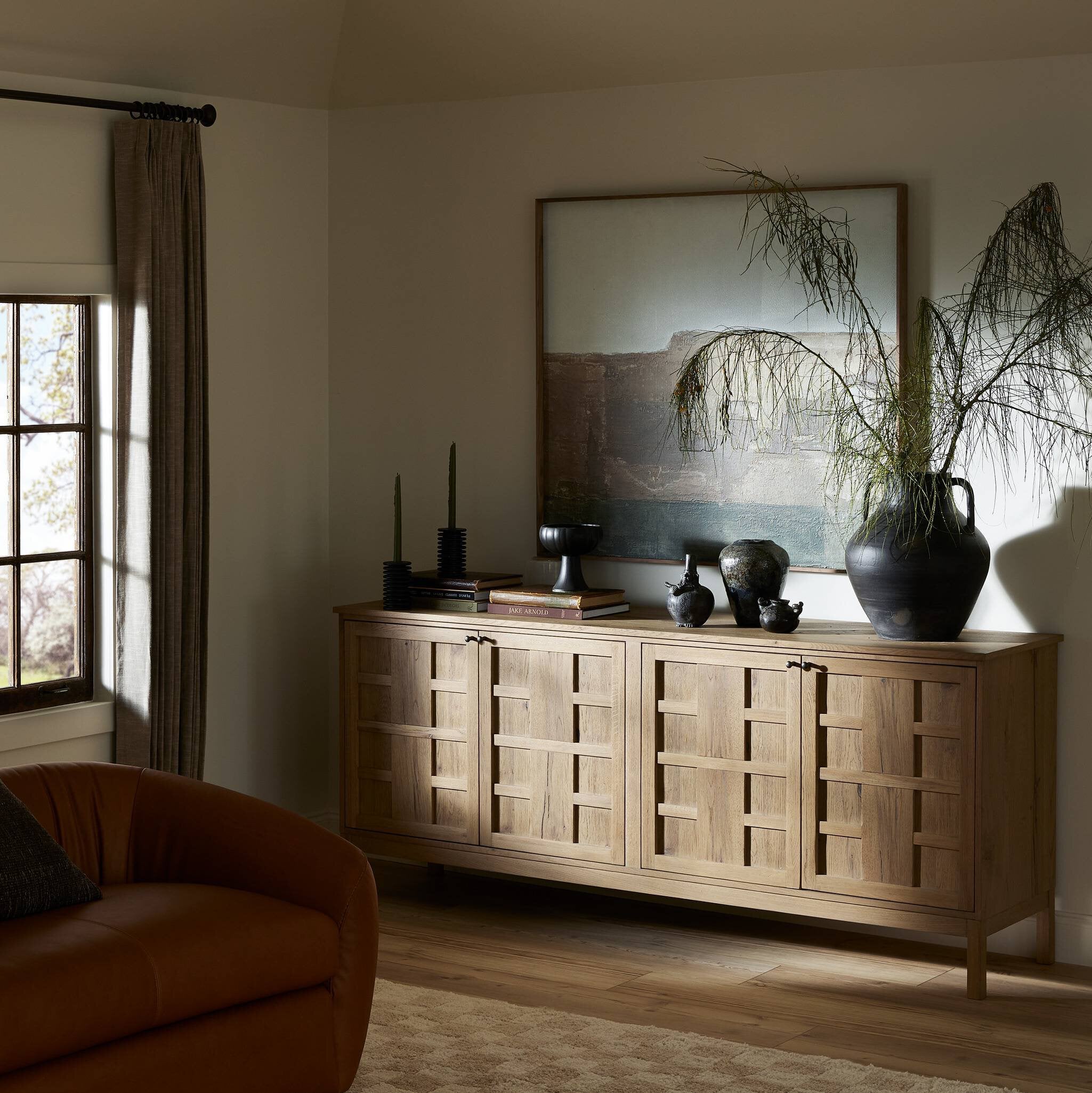 Wooden sideboard with decorative items in a living room setting
