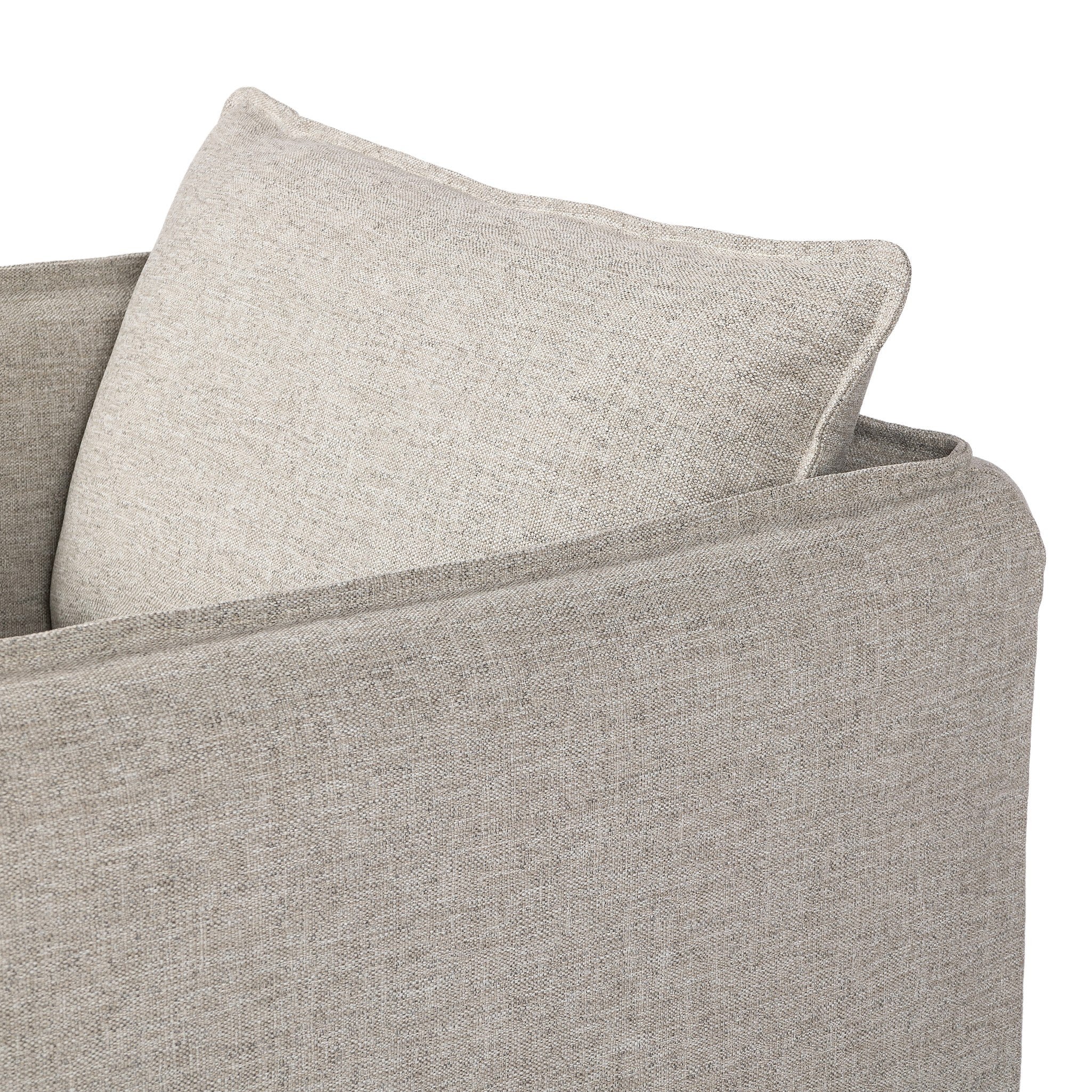 Close up of a neutral gray outdoor swivel armchair with a pillow on a white background.