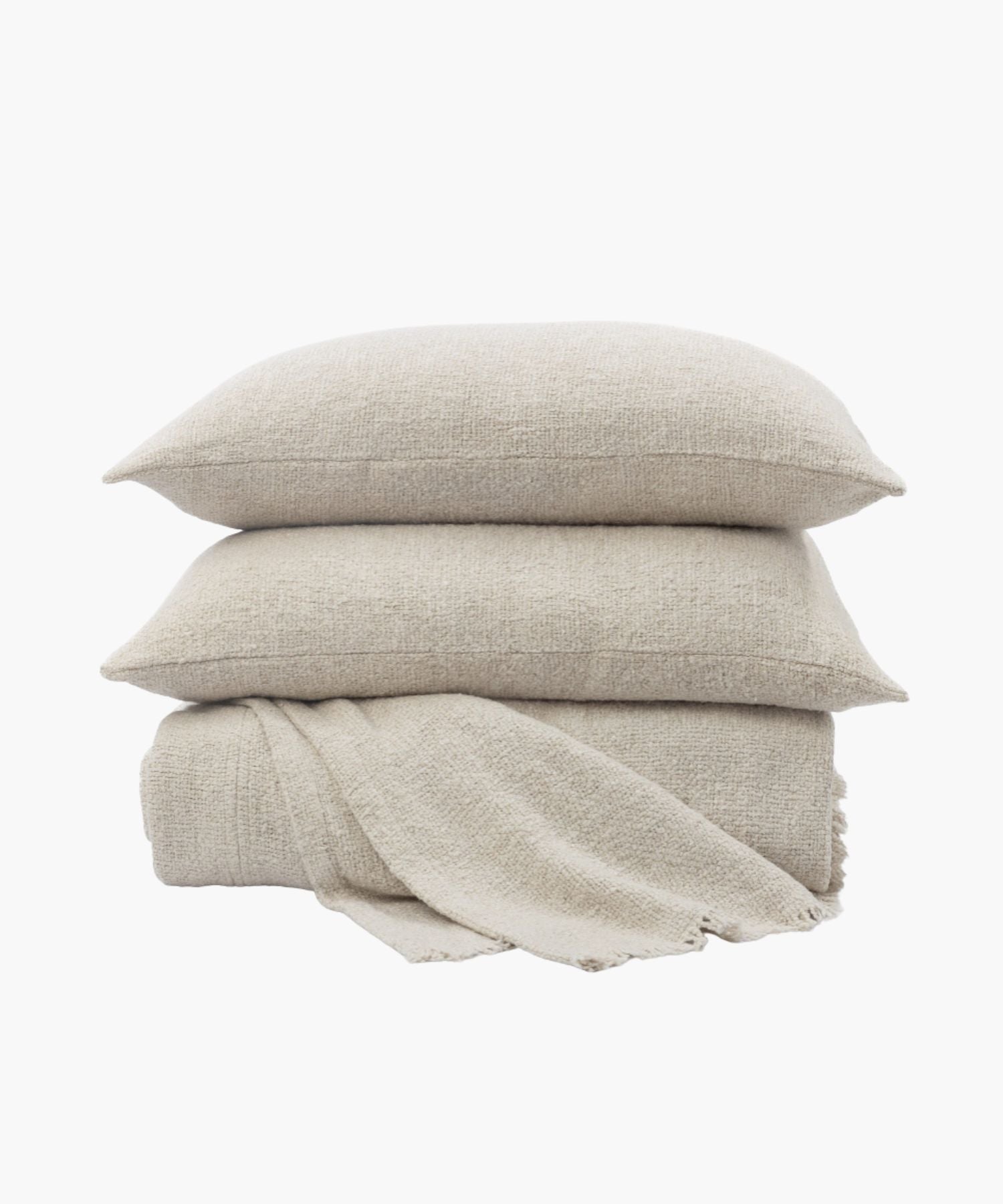 Close-up of boucle coverlet with boucle texture and soft drape over the bedding surface.