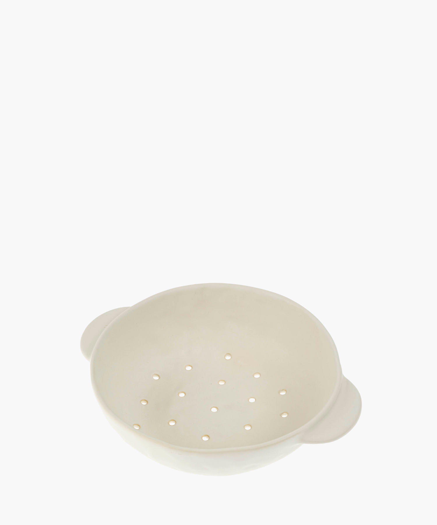 A white ceramic colander features a smooth finish and two handles, with evenly spaced drainage holes, conveying a minimalistic and functional design.