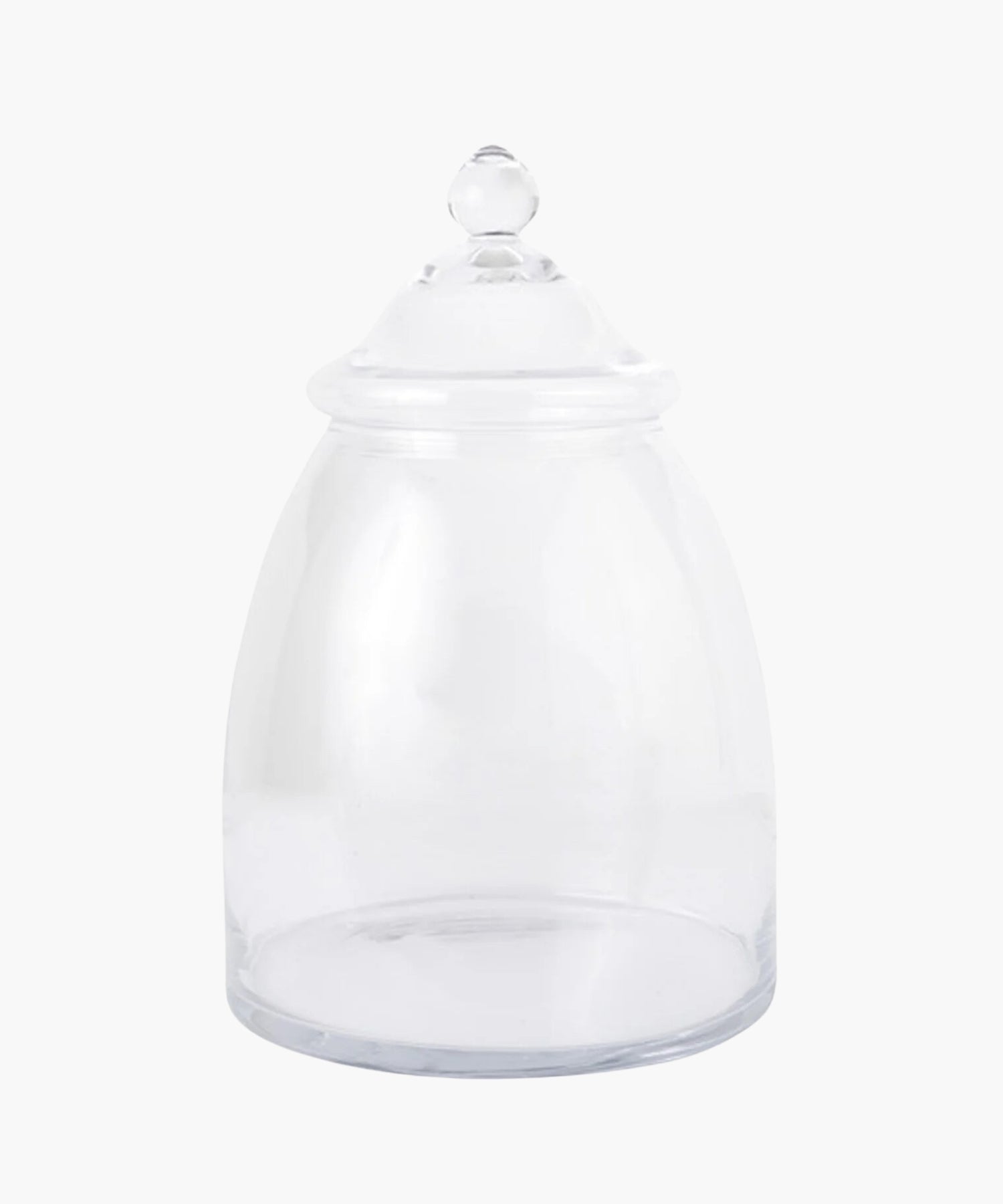 A clear glass apothecary jar with a domed lid and rounded knob. The jar is empty, evoking a sense of simplicity.
