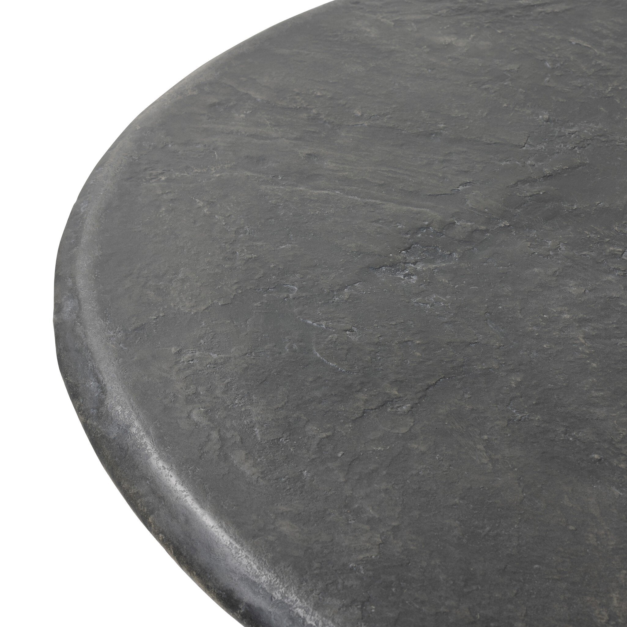 Close up of a round black concrete dining table on a white background.