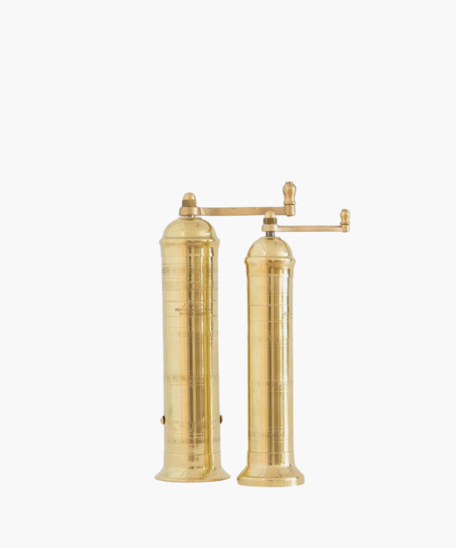Tall, cylindrical brass pepper mill and salt mill with a decorative pattern and a side handle, conveying elegance.