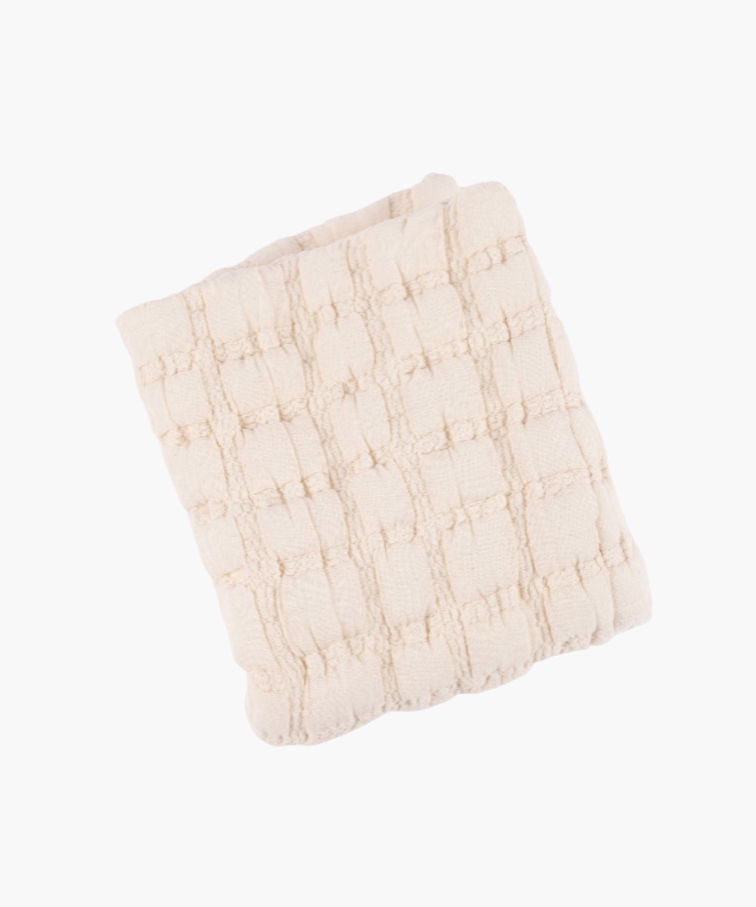 Folded view of a cream quilt with a soft, puffed grid texture and subtle stitched detailing.