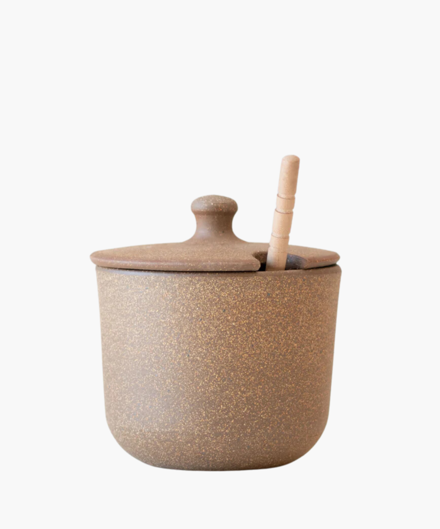 A rustic brown ceramic sugar jar or honey pot with a speckled texture and a lid, featuring a subtle slot for a wooden spoon, conveying a cozy, earthy vibe.
