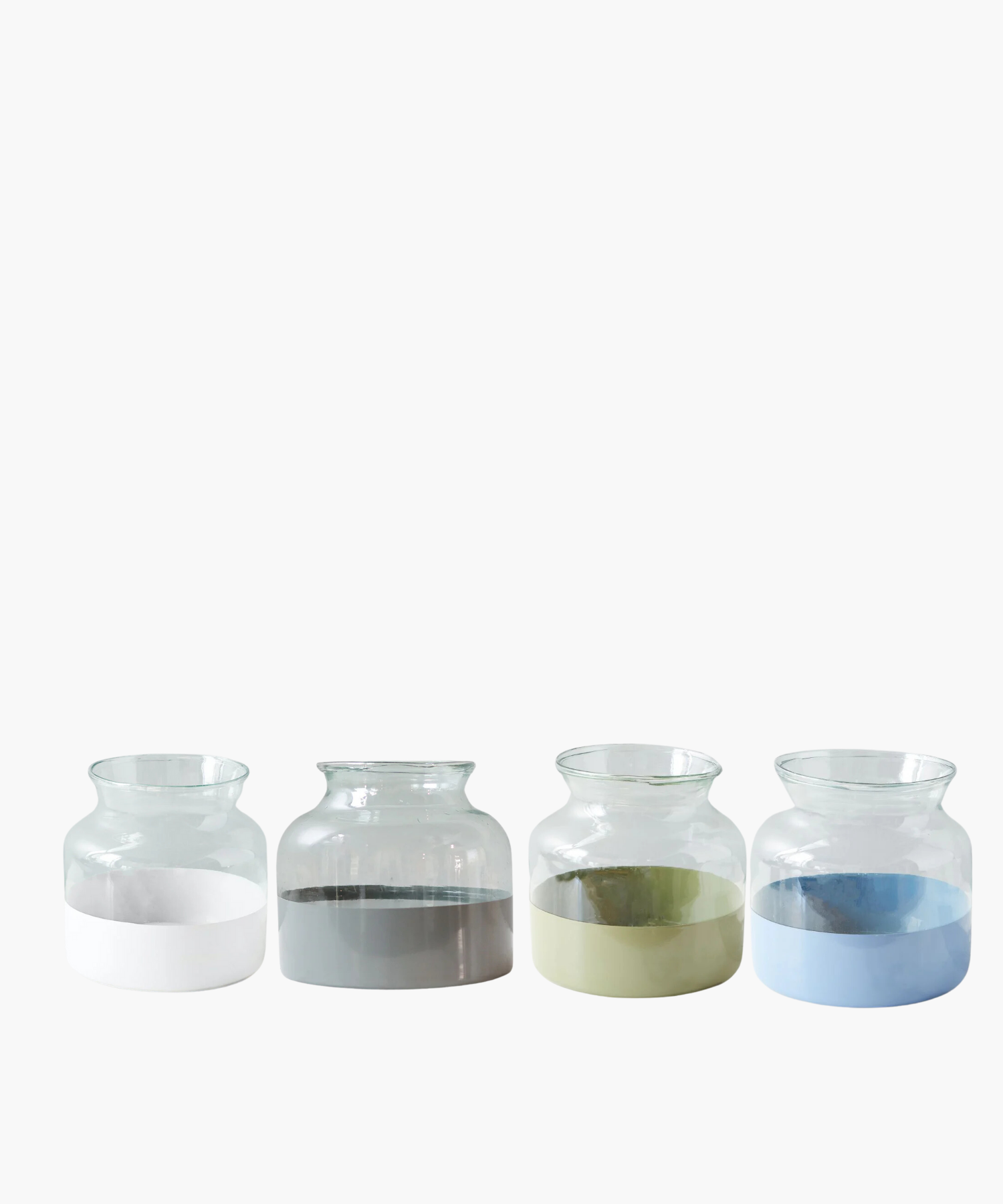 Four clear glass vases with a wide mouth and rounded body. The upper part is transparent, while the lower half is painted in a glossy white, gray, sage, and french blue. Minimalist and modern.