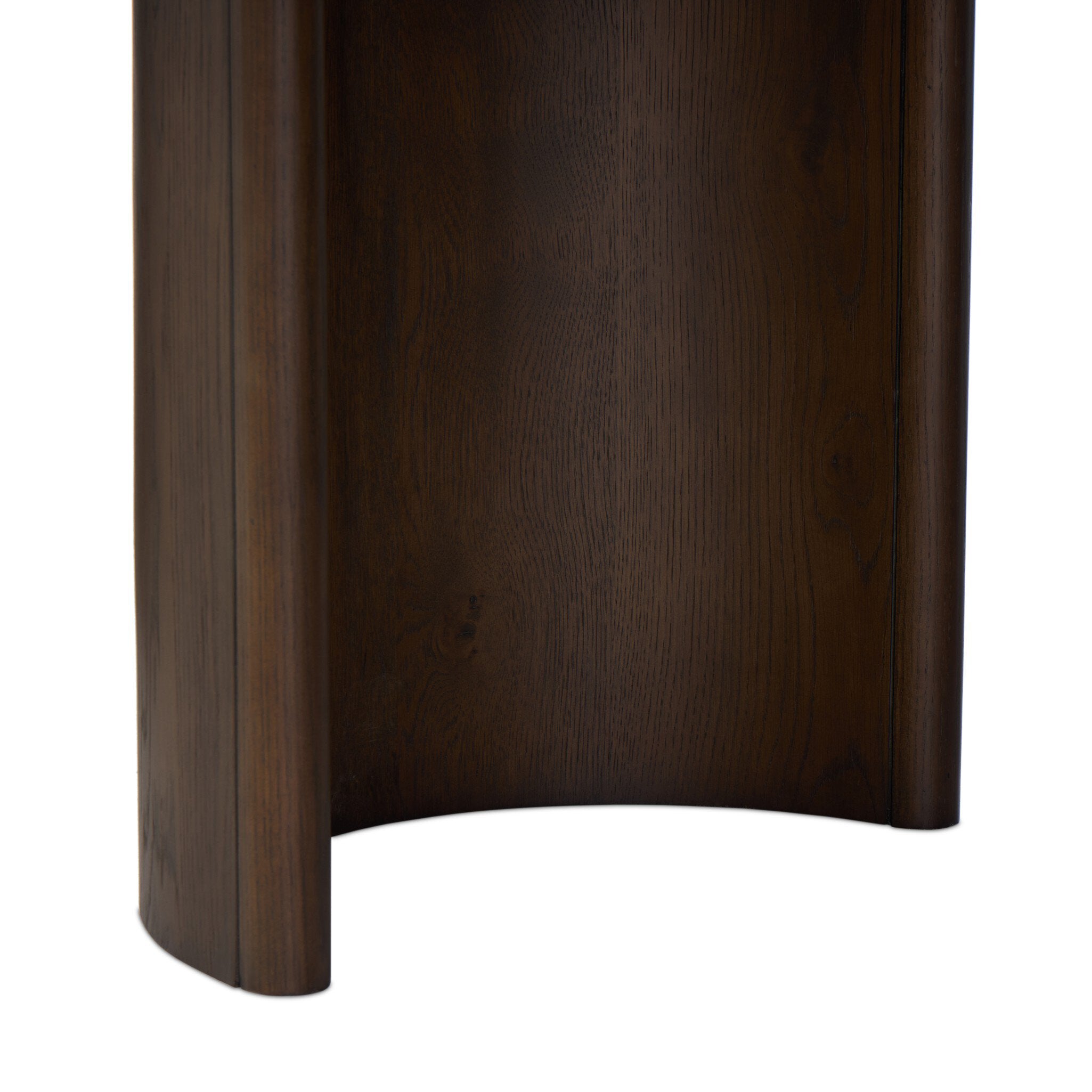 Close up of a wood dining table with a minimalist design on a white background.