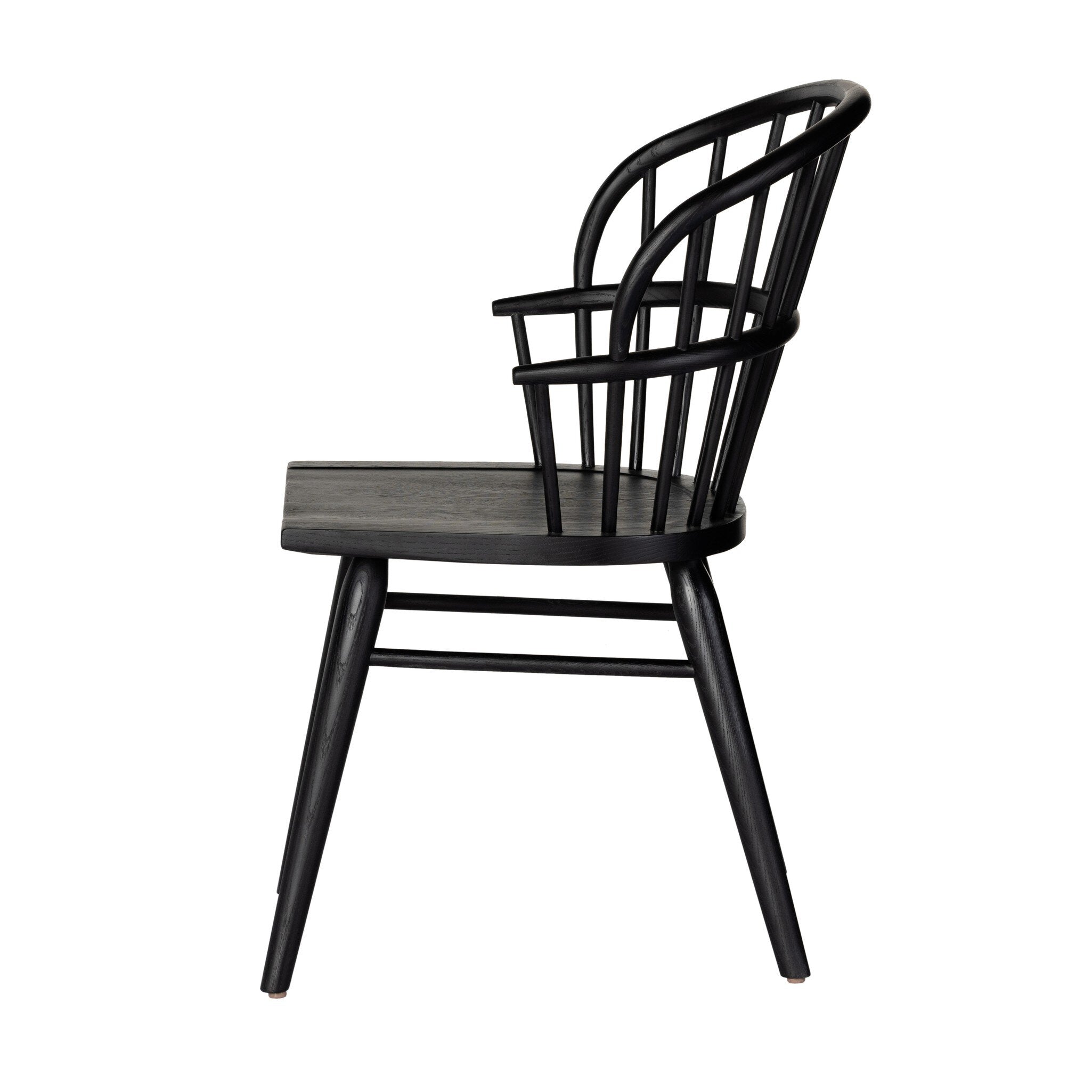 Side profile of a black dining chair with a minimalist design on a white background.