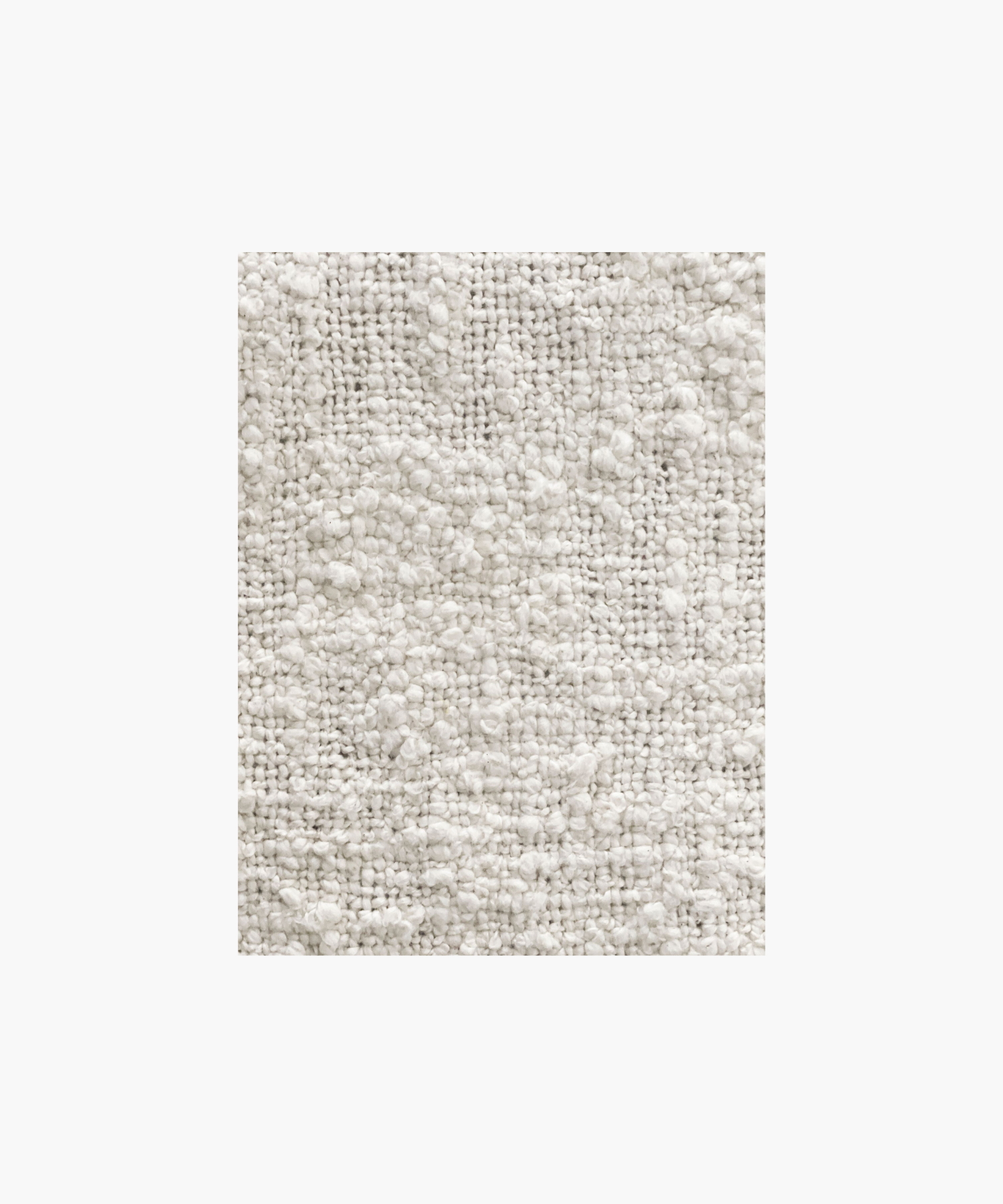 A soft, ivory colored woven throw blanket highlighting the textured pattern and color conveying a cozy and inviting feel.