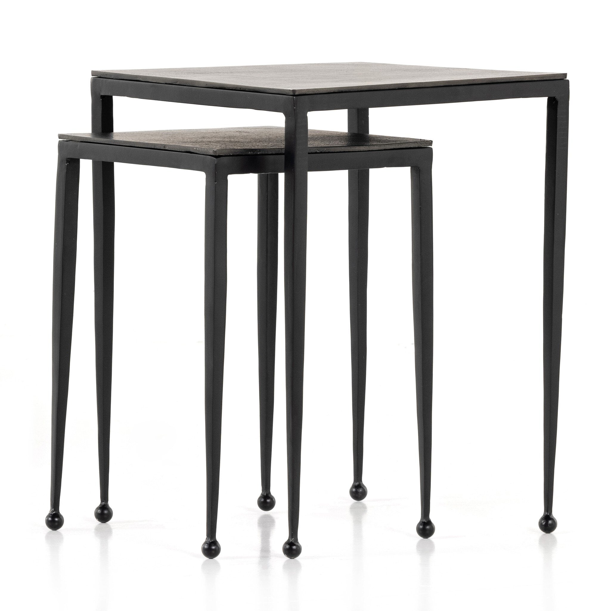 Two black nesting tables with tapered legs and squared off aluminum tops on a white background.