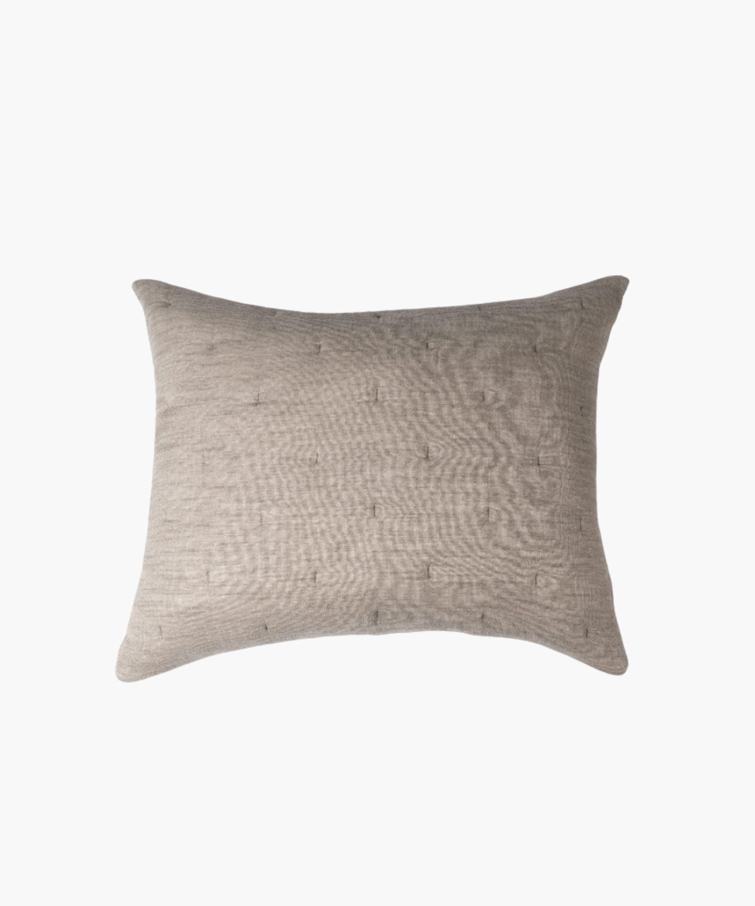 Rectangular beige textured pillow on a white background highlighting fabric texture, stitching, and finish.
