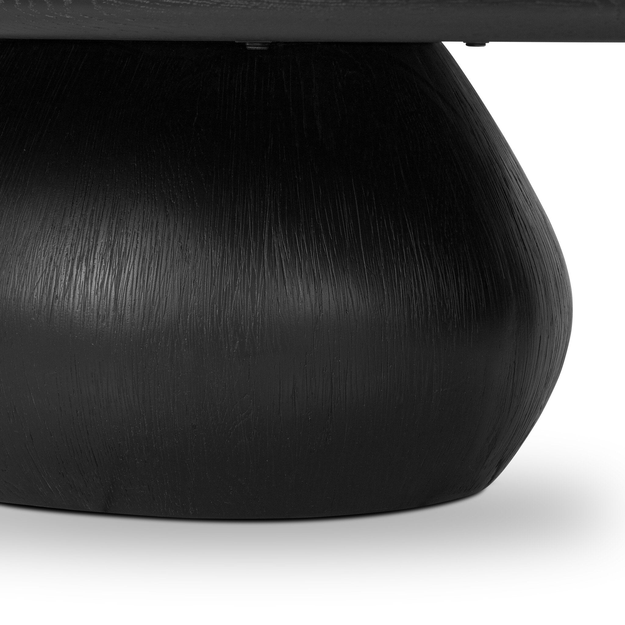 Close up of a black oval shaped coffee table on a white background.