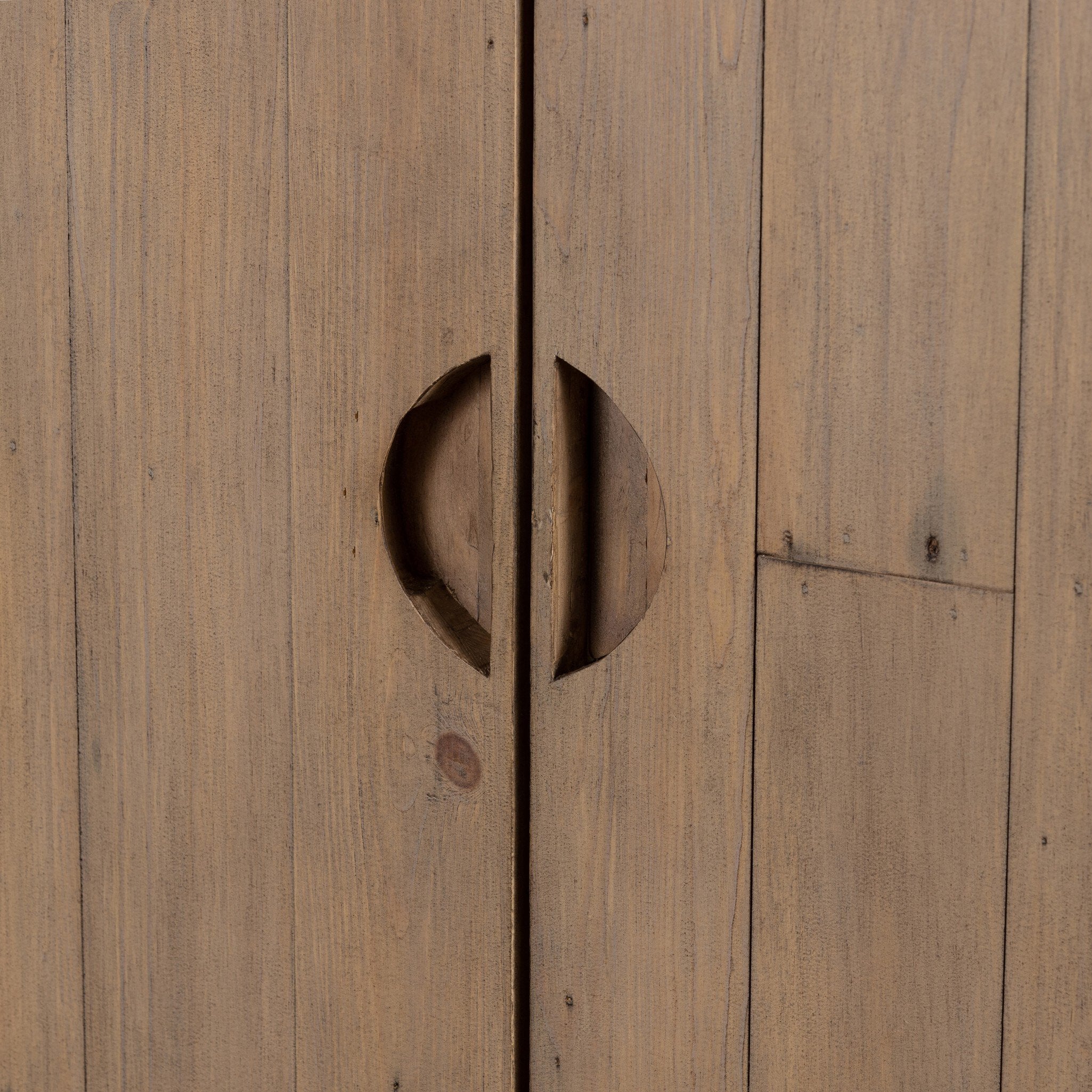 Close up of a wooden cabinet with two doors and rounded corners on a white background.