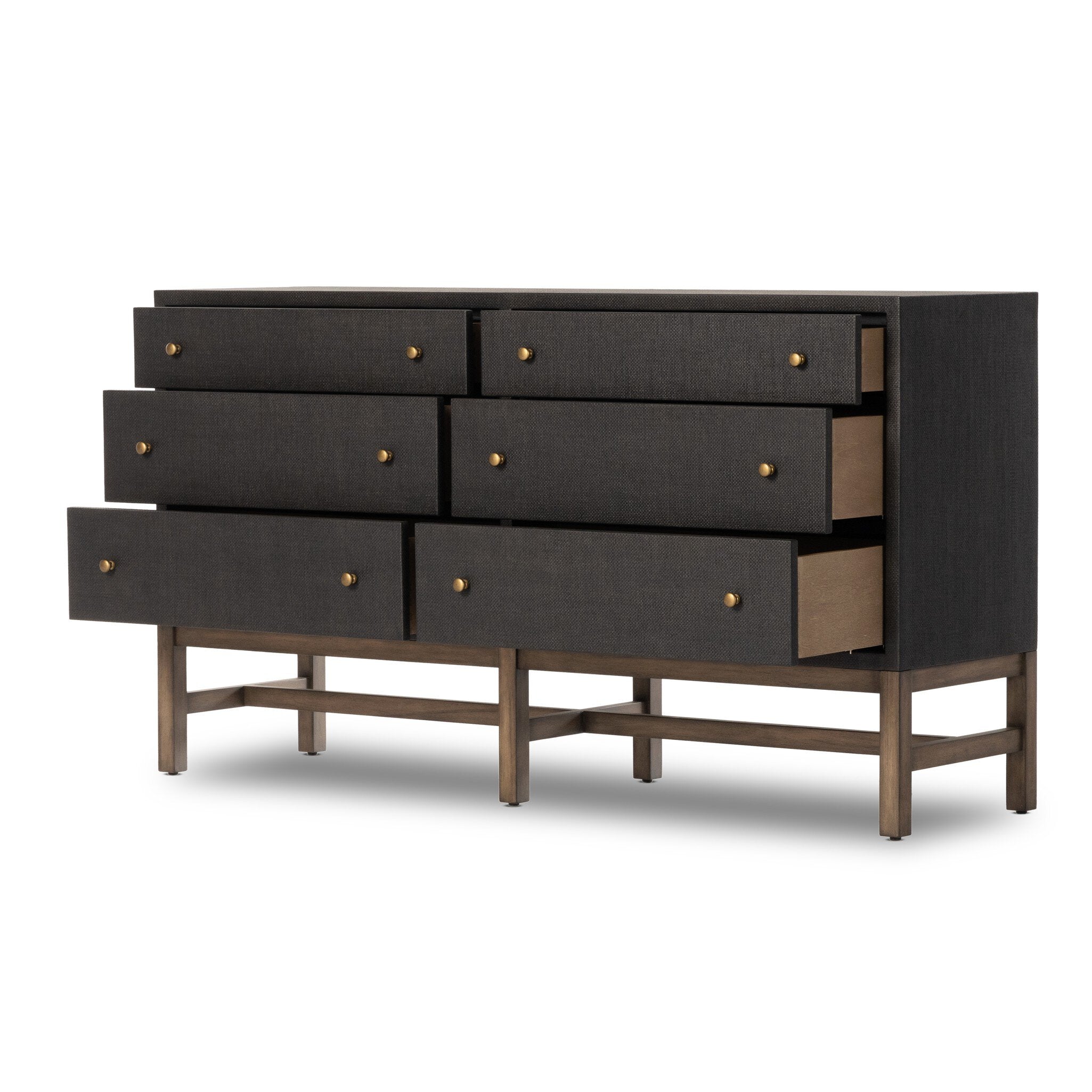 A black dresser with brass knobs with wooden legs on a white background.