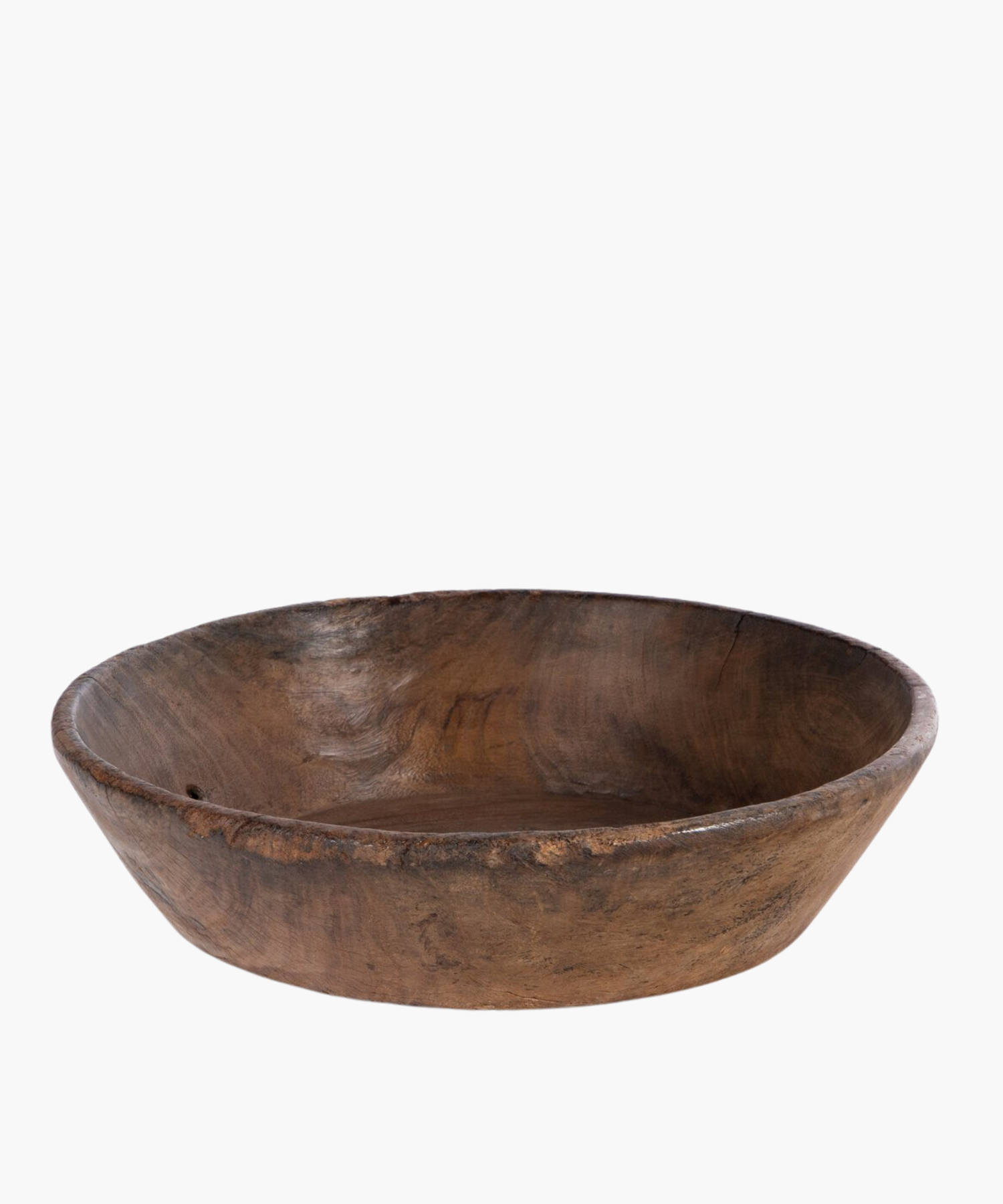 Large rustic wooden bowl with a smooth, rounded interior and rough, textured exterior. The natural grain and earthy tones suggest simplicity and warmth.
