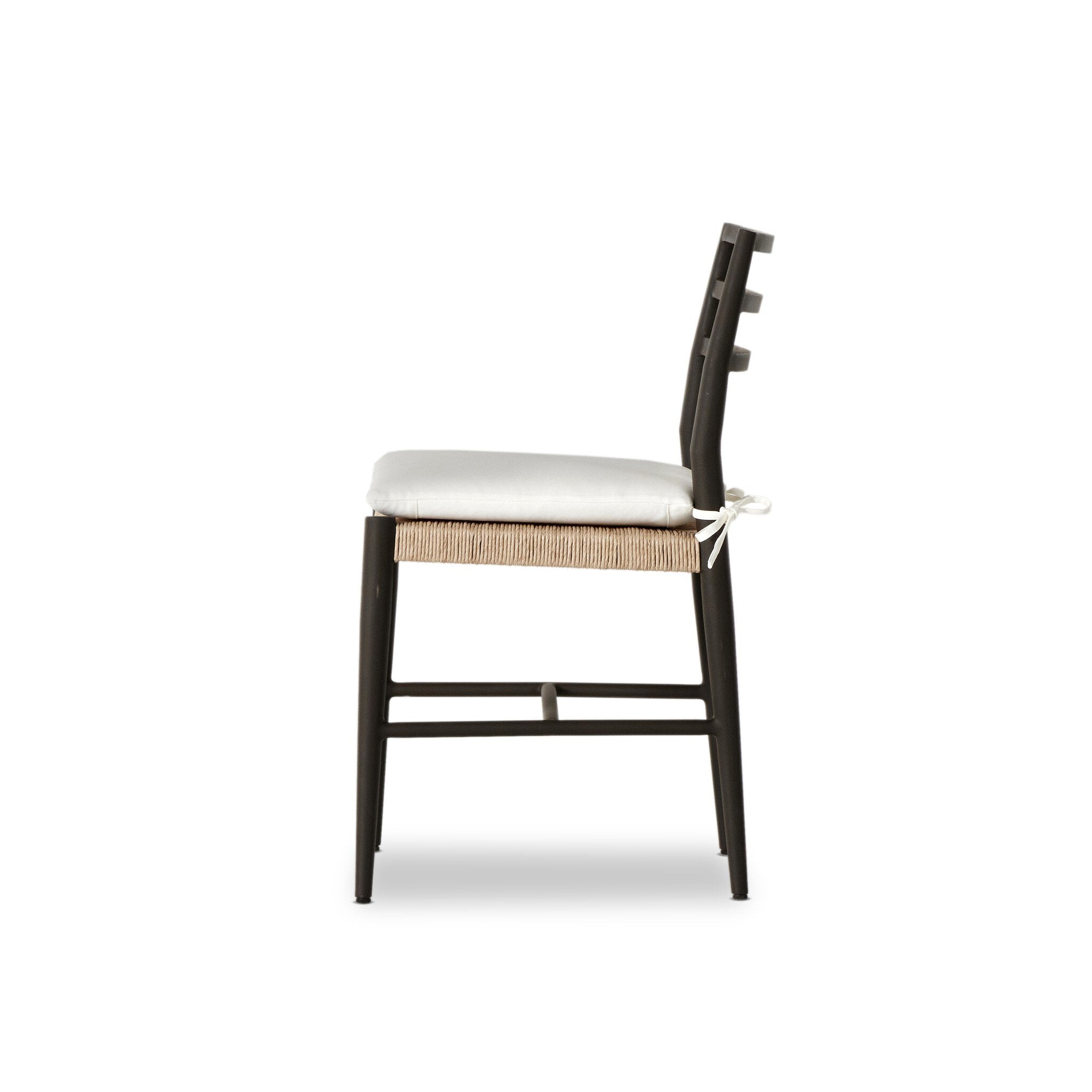 Side profile of a classic ladderback outdoor dining chair with a woven seat and removable cushion.