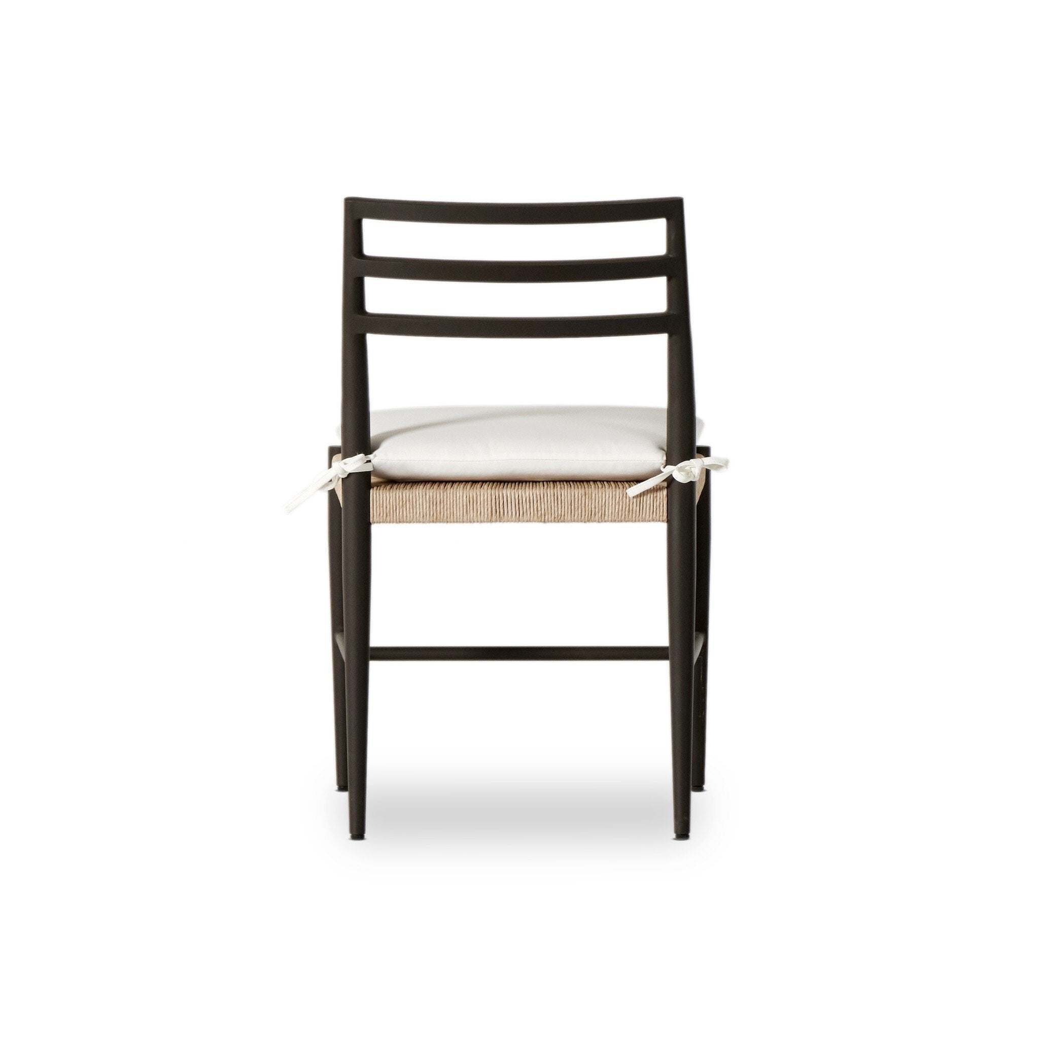 The back of a classic ladderback outdoor dining chair with a woven seat and removable cushion.