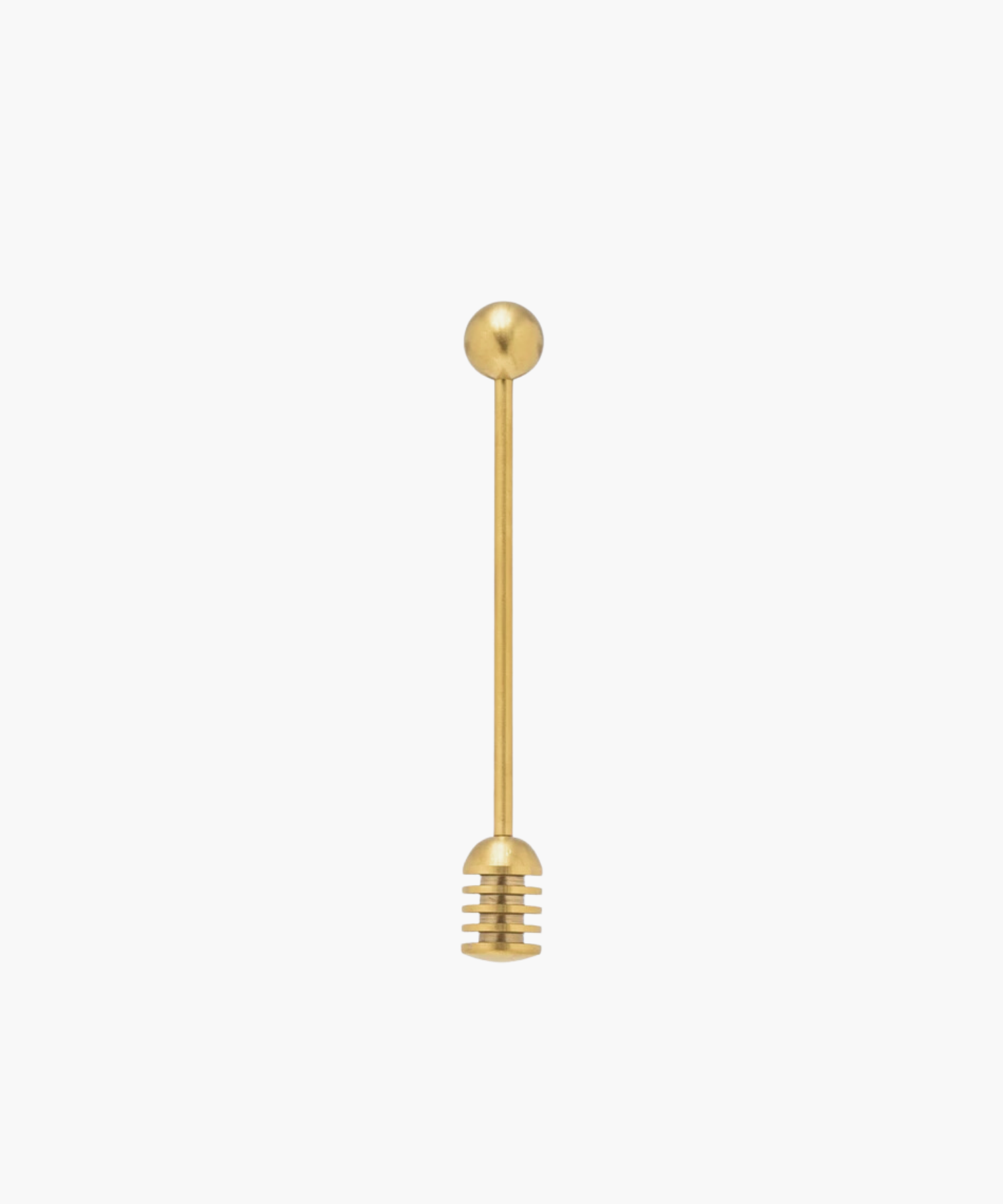 Gold honey dipper with a round handle and grooved end for collecting honey, set against a plain white background. Simple and elegant kitchen tool.