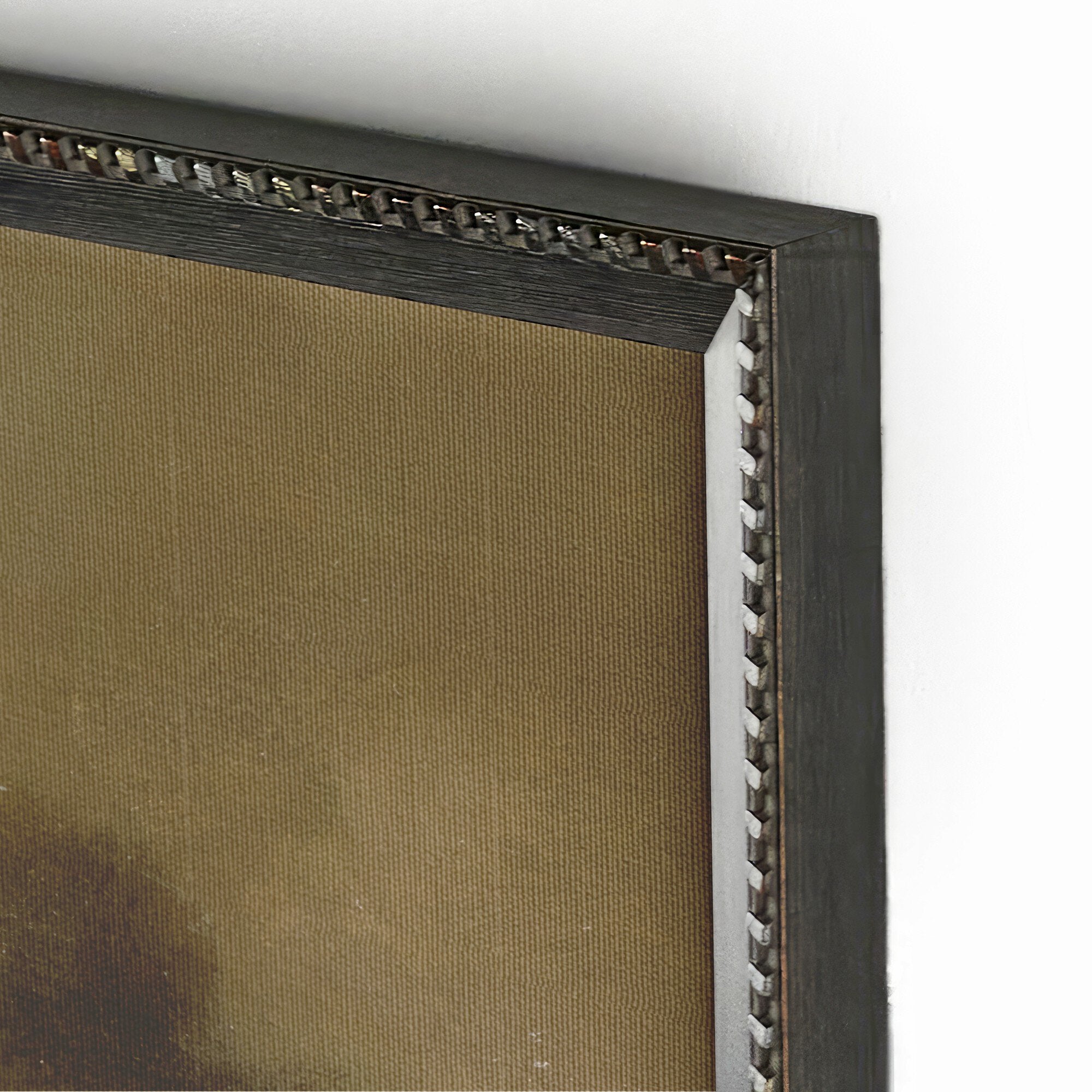 Close-up of a dark wooden picture frame with decorative elements on a white background