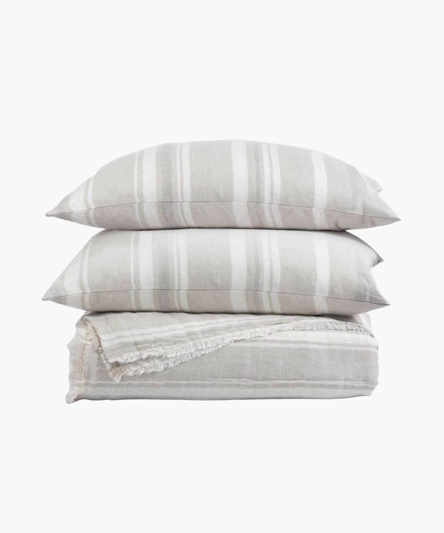 Stacked view of coverlet and shams in a soft taupe and white stripe pattern with fringe edge detail, highlighting its light texture.