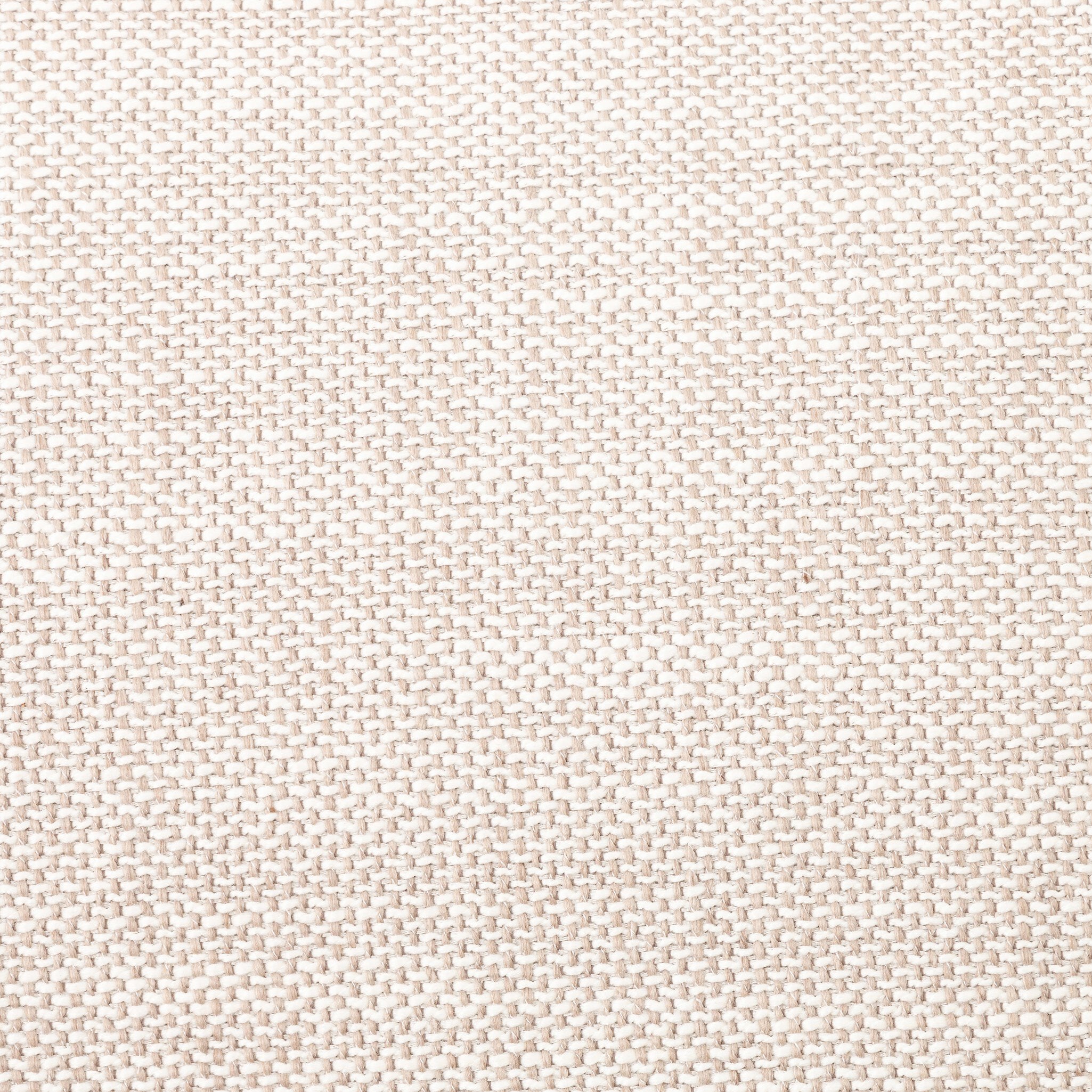 Close up of a beige armchair with dark metal legs on a white background.