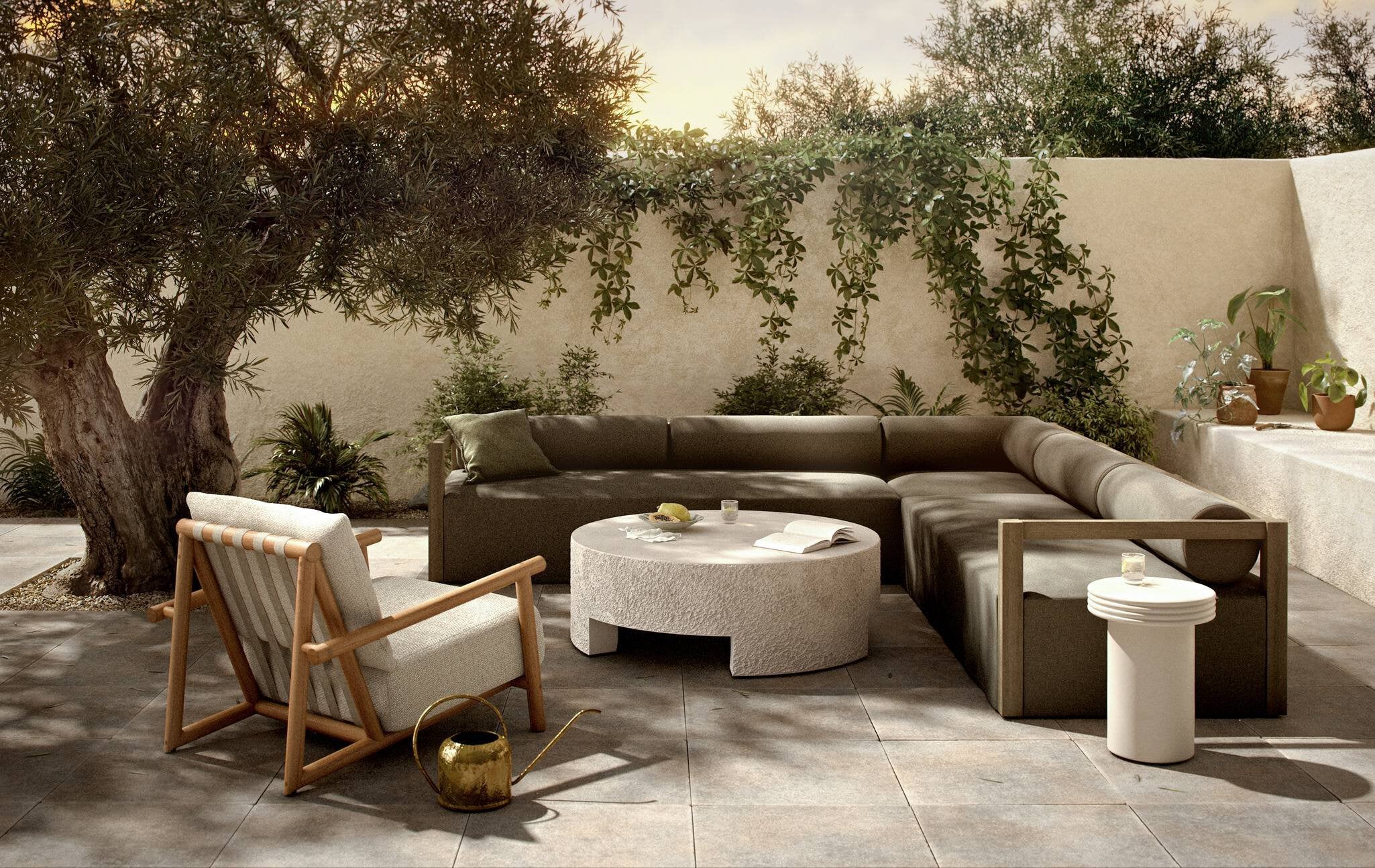 Outdoor patio with brown sectional sofa, wooden armchair, and round concrete coffee table.