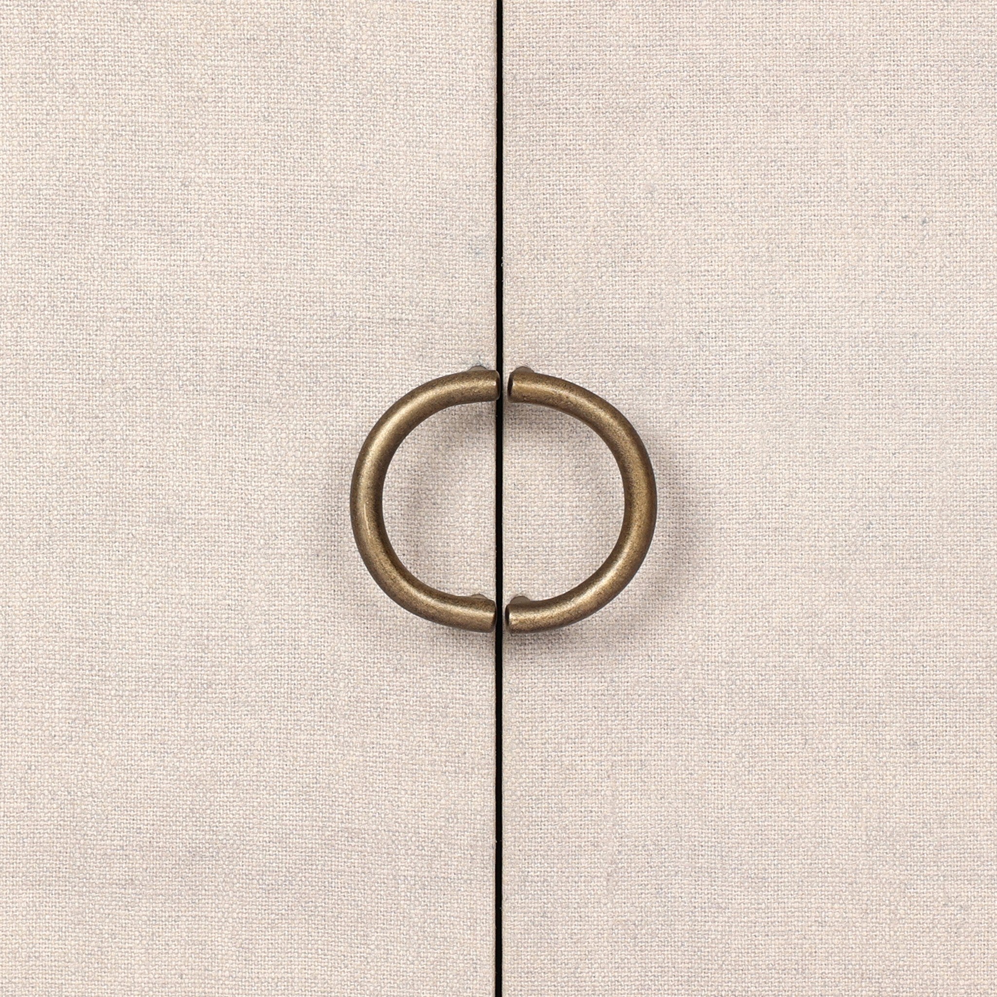 Close up of a small cabinet style nightstand with two doors and split circle hardware on a white background.