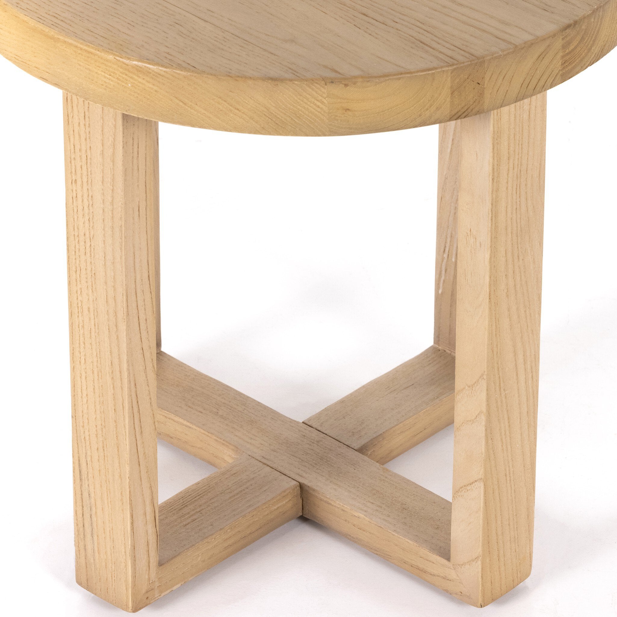 Solid natural nettlewood end table with an open cross-style base and thick, rounded table top on a white background.