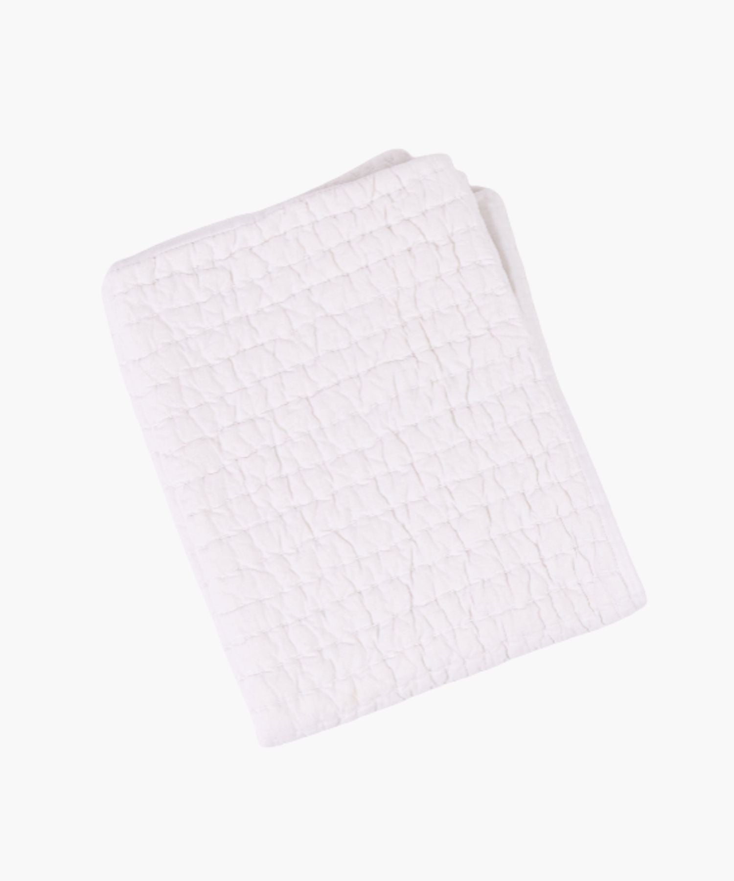 Flat lay of the Maegan Quilt in white, showing its hand-quilted Kantha-style stitching in a grid pattern and lightweight voile texture.