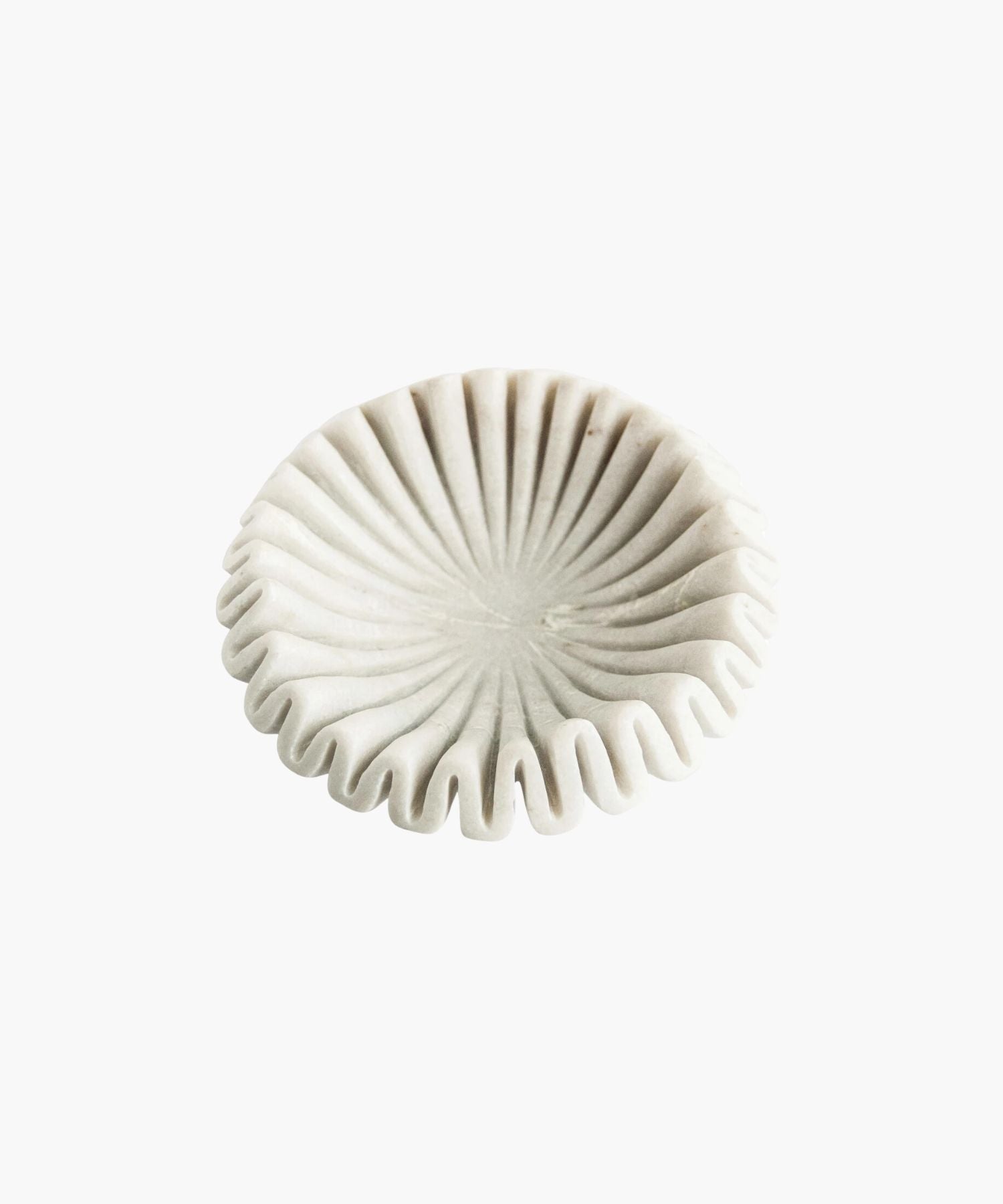 Overhead view of an elegant white marble bowl with a pleated, fan-like design. Its sculptural form and soft shadows create a minimalist and artistic appeal