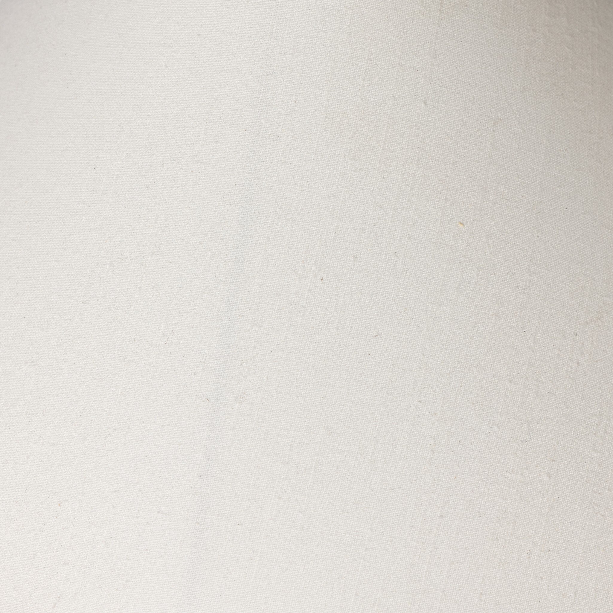 Close up of the ivory lamp shade showing its color and fabric texture.