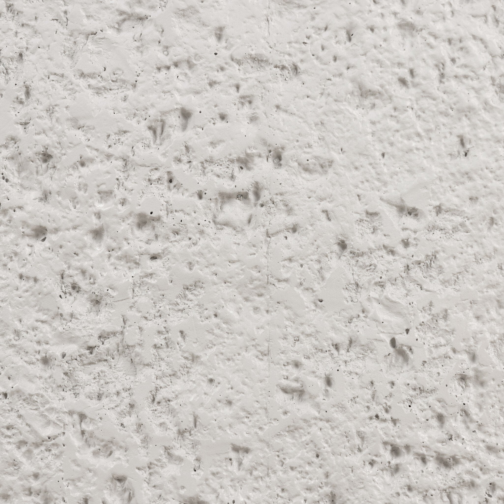 Close up of the raw edges of the concrete coffee table showing its texture.