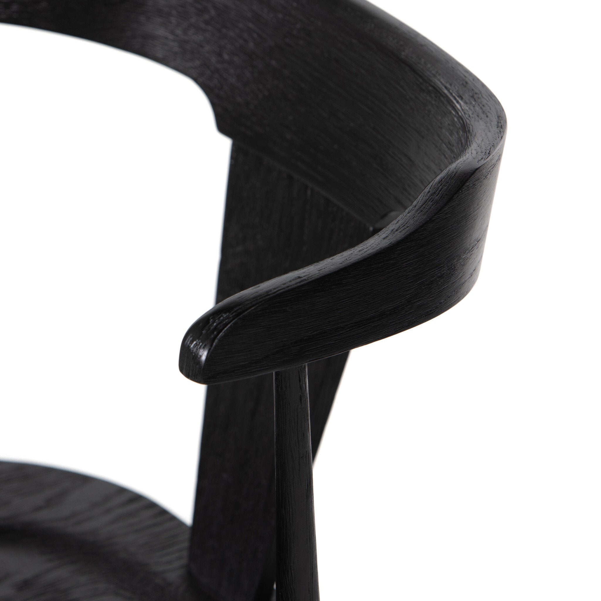 Close up of a black wooden dining chair on a white background.