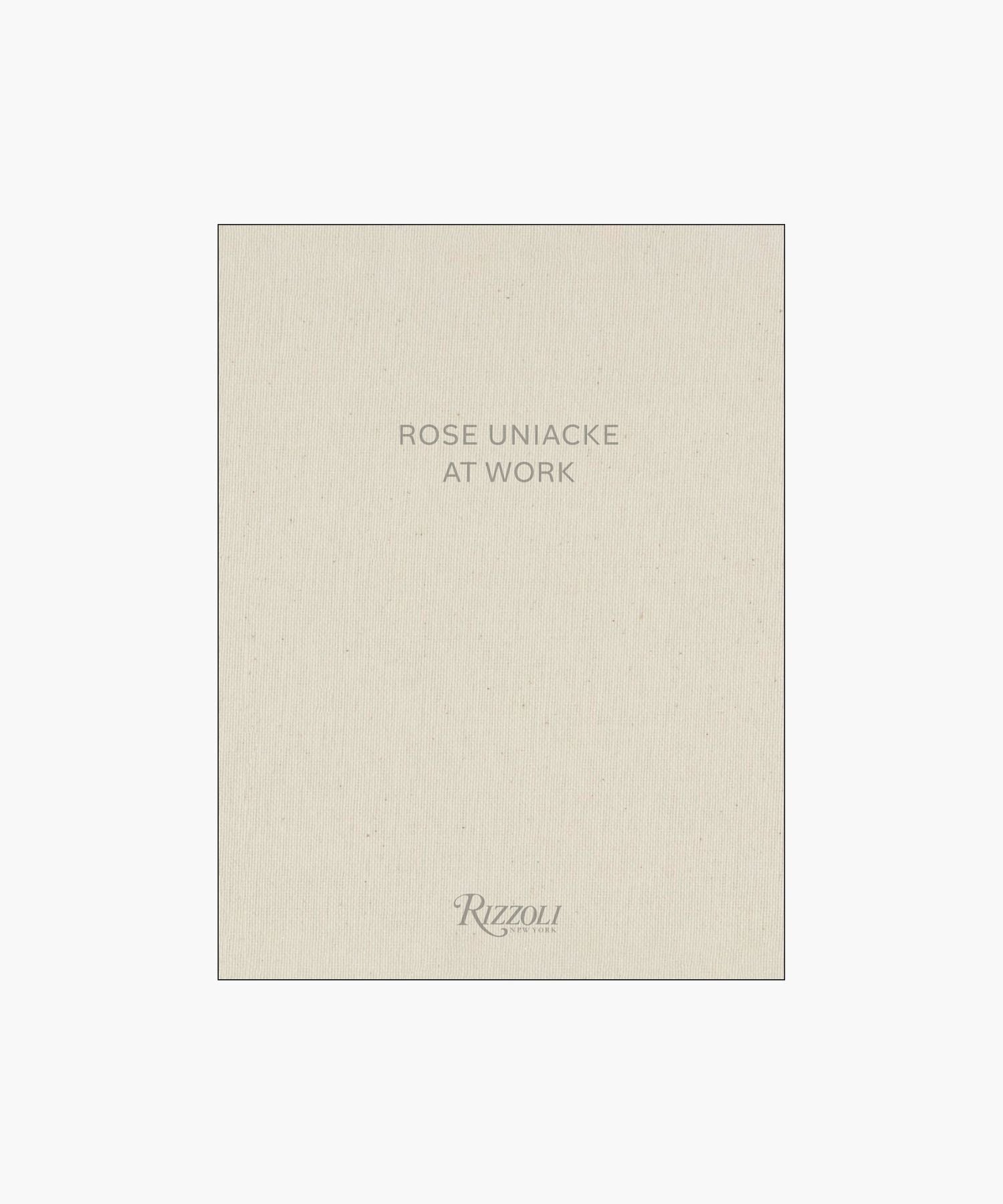 Cover of the book "Rose Uniacke at Work," featuring a minimalist design with beige fabric texture and gray text.