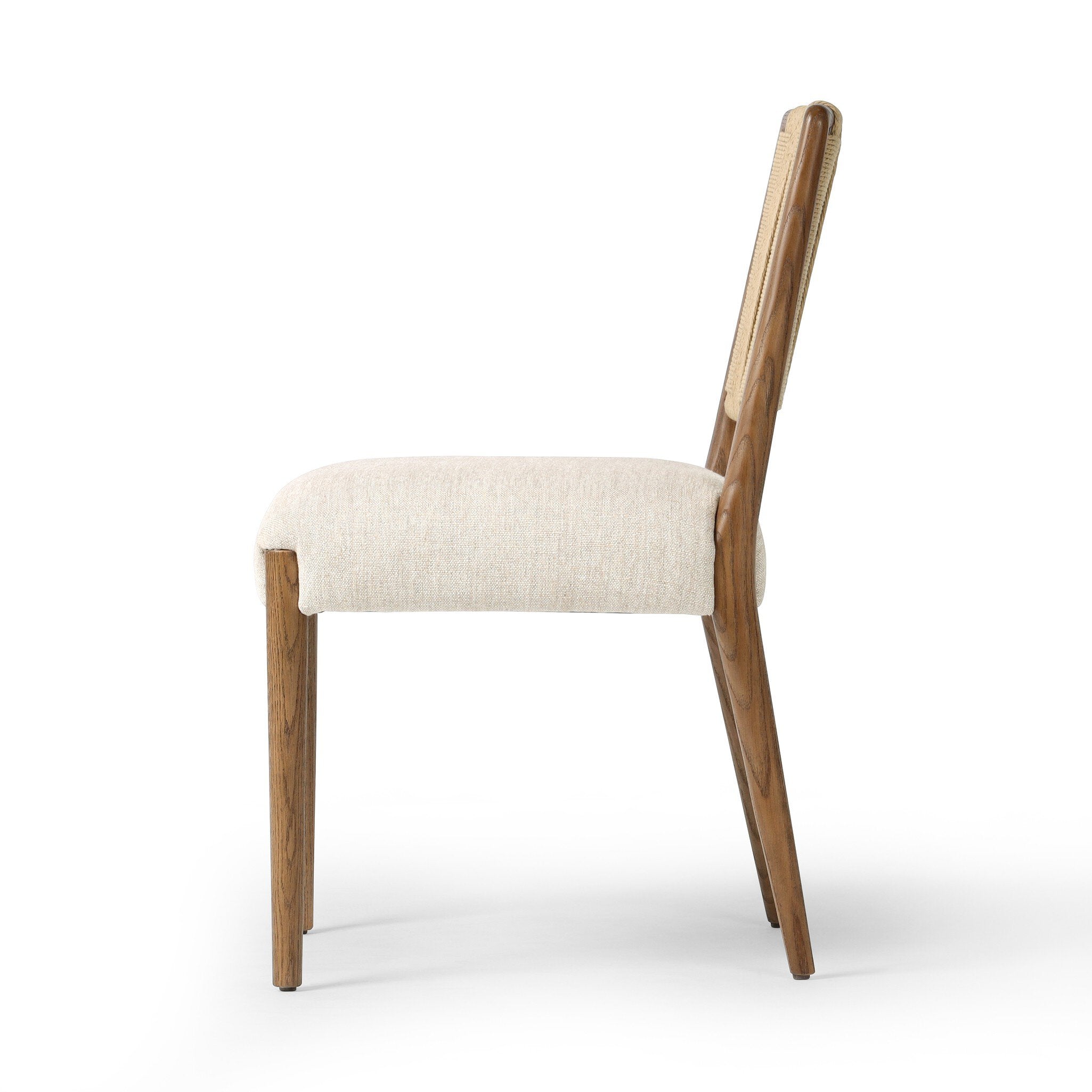 Side profile of a dining chair with woven backrest and beige cushion on a white background.