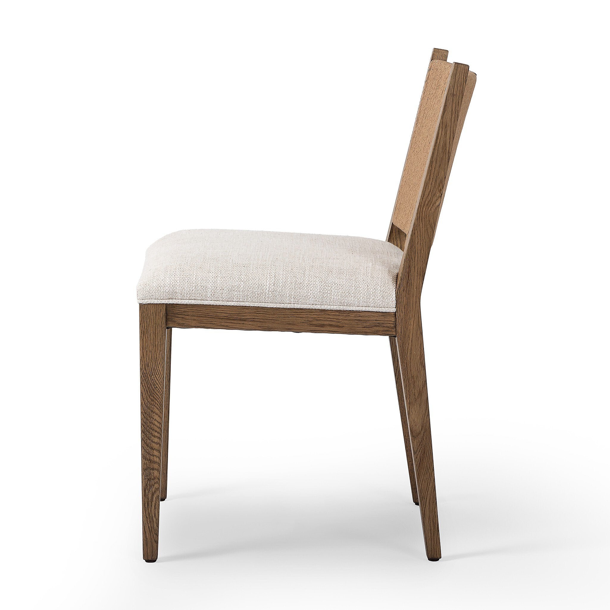 Side profile of a wooden dining chair with a woven backrest and white cushion on a white background.