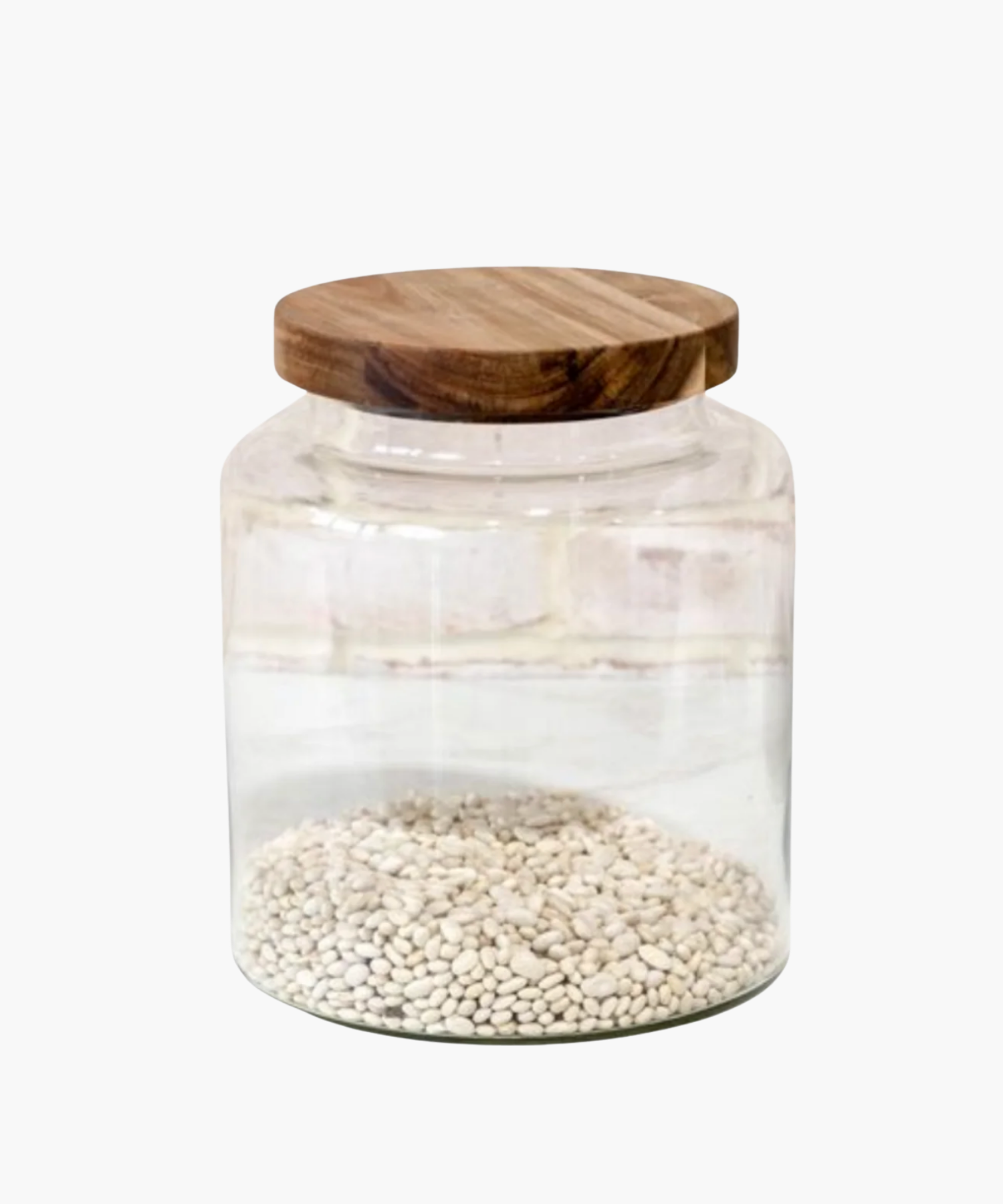 A large clear glass jar with a wooden lid, filled with dried white beans. The clean, minimalist design conveys a rustic, cozy feel.