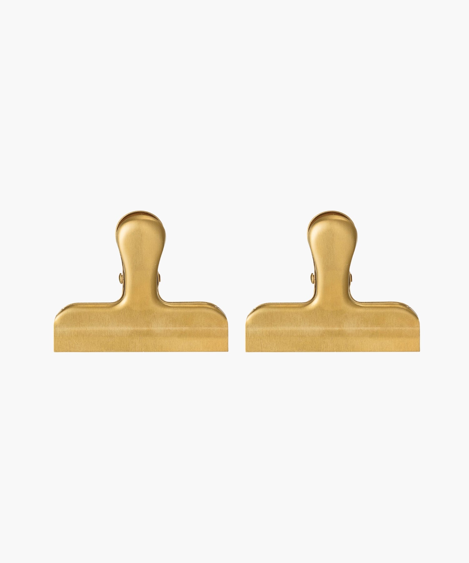 Two gold-colored metal binder clips. The clips are large, with a smooth finish, conveying a utilitarian feel.