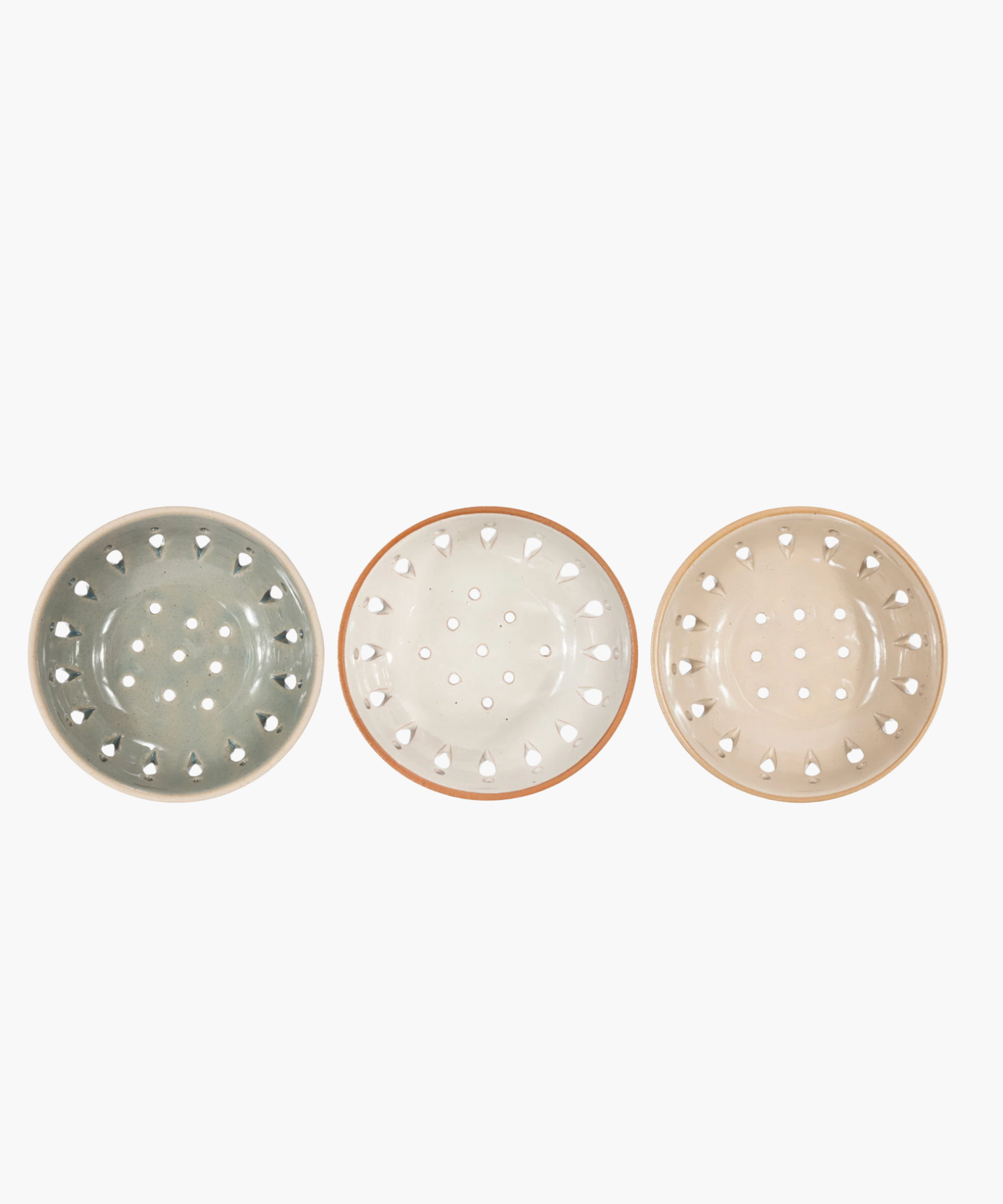 Three colanders in muted beige and gray tones are evenly spaced in a row. Each has a sleek, modern design with decorative cutout patterns.
