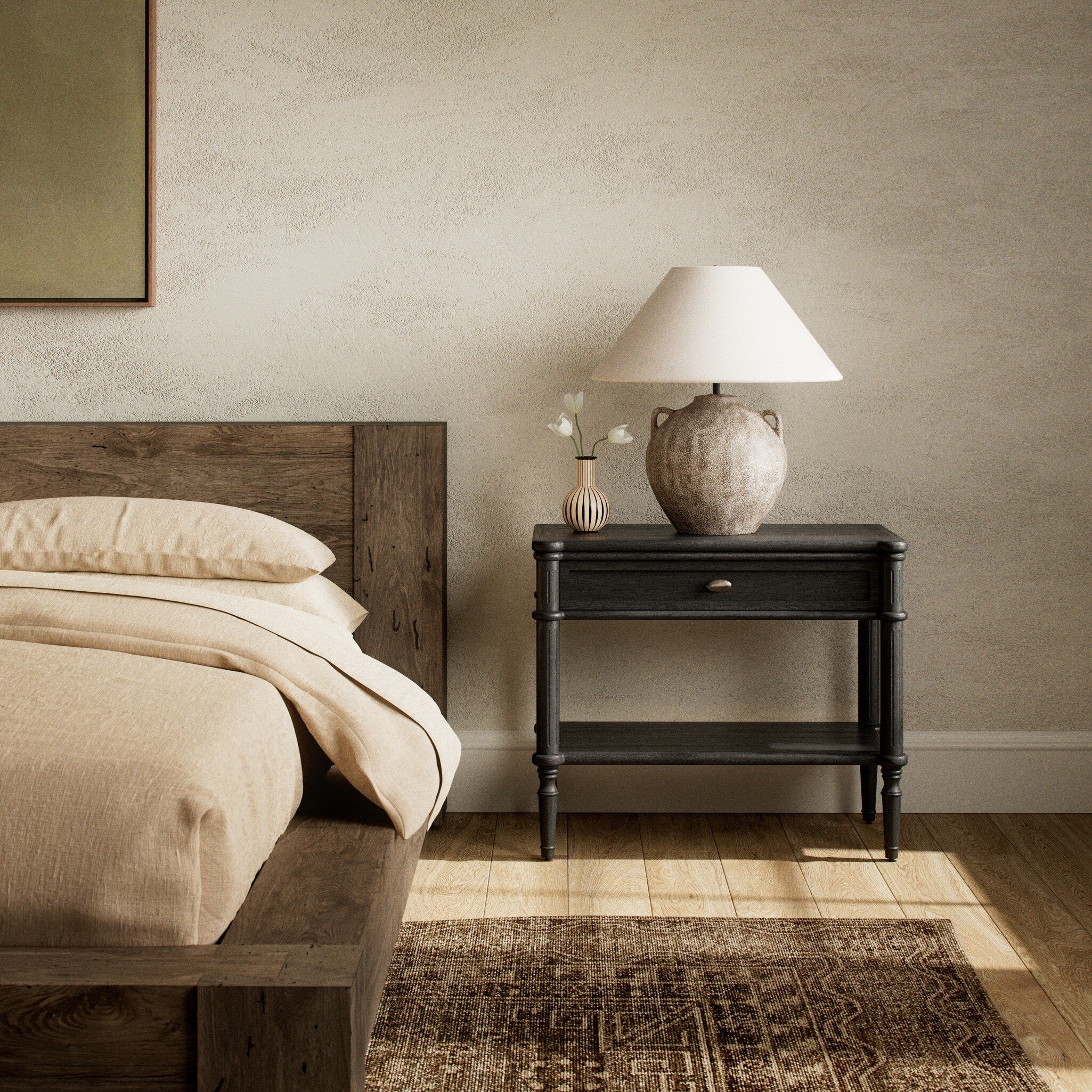 Bedroom with wooden bed, black nightstand, and lamp.