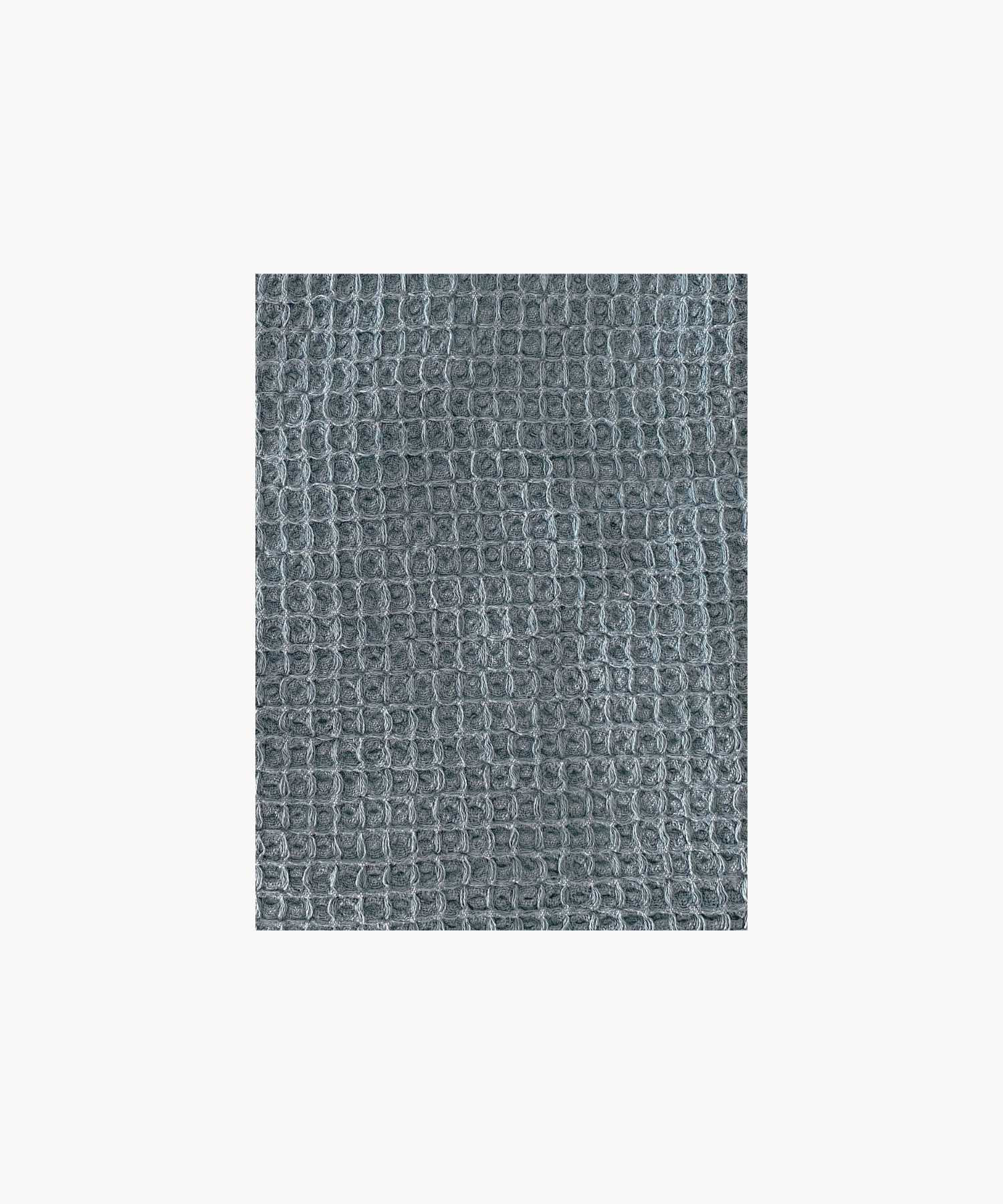 Close up of the vintage blue waffle-textured throw blanket highlighting the texture and color. The soft material conveys a cozy, inviting feel. Suitable for any living room or bedroom.