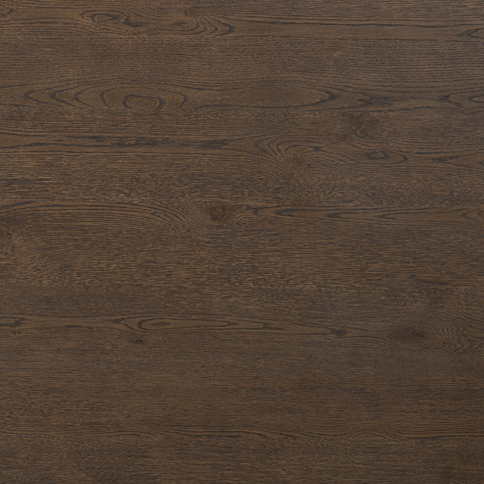 Close up of the dining table showing its dark brown color and wood grain.