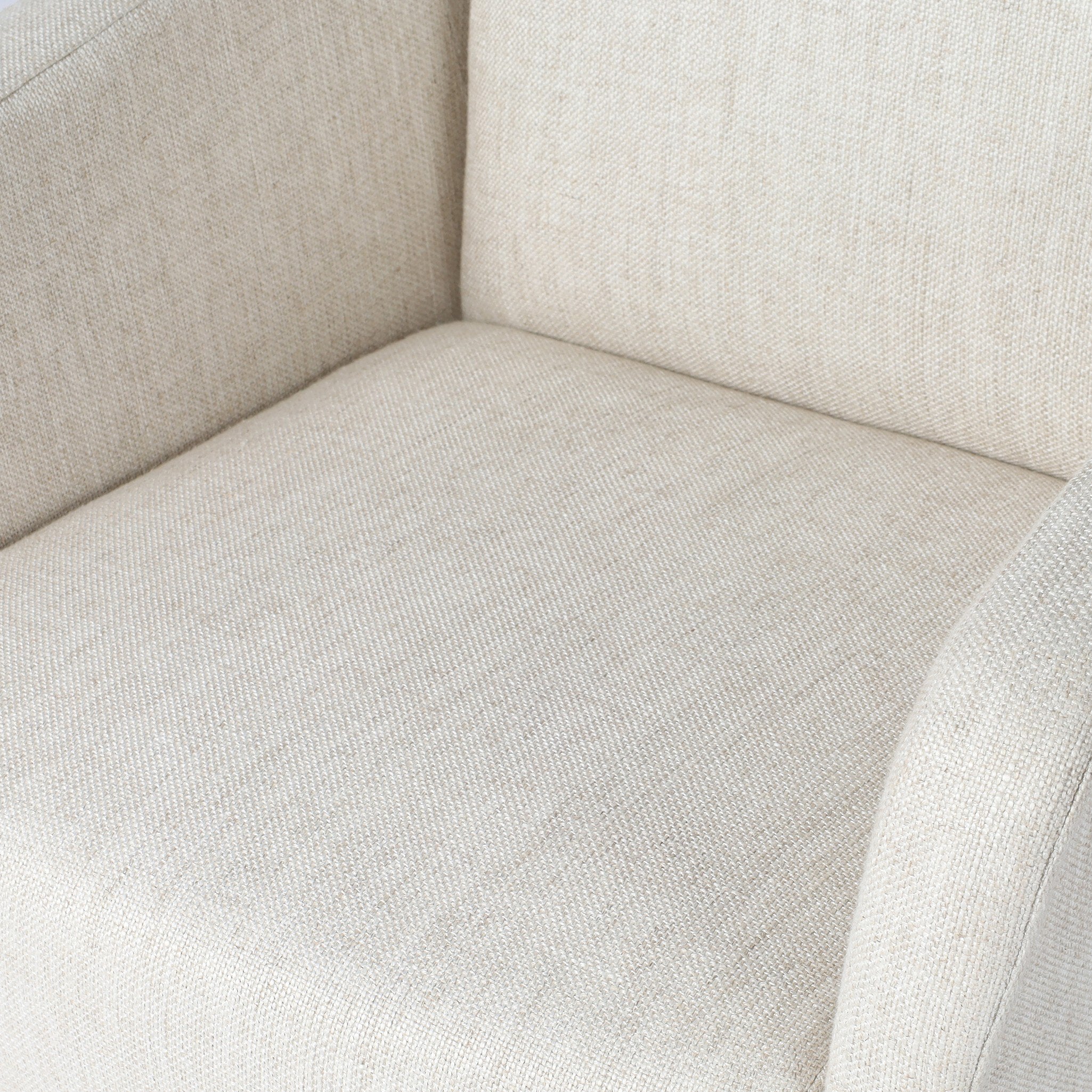 Side profile of an ivory upholstered desk chair with a chrome base on a white background.
