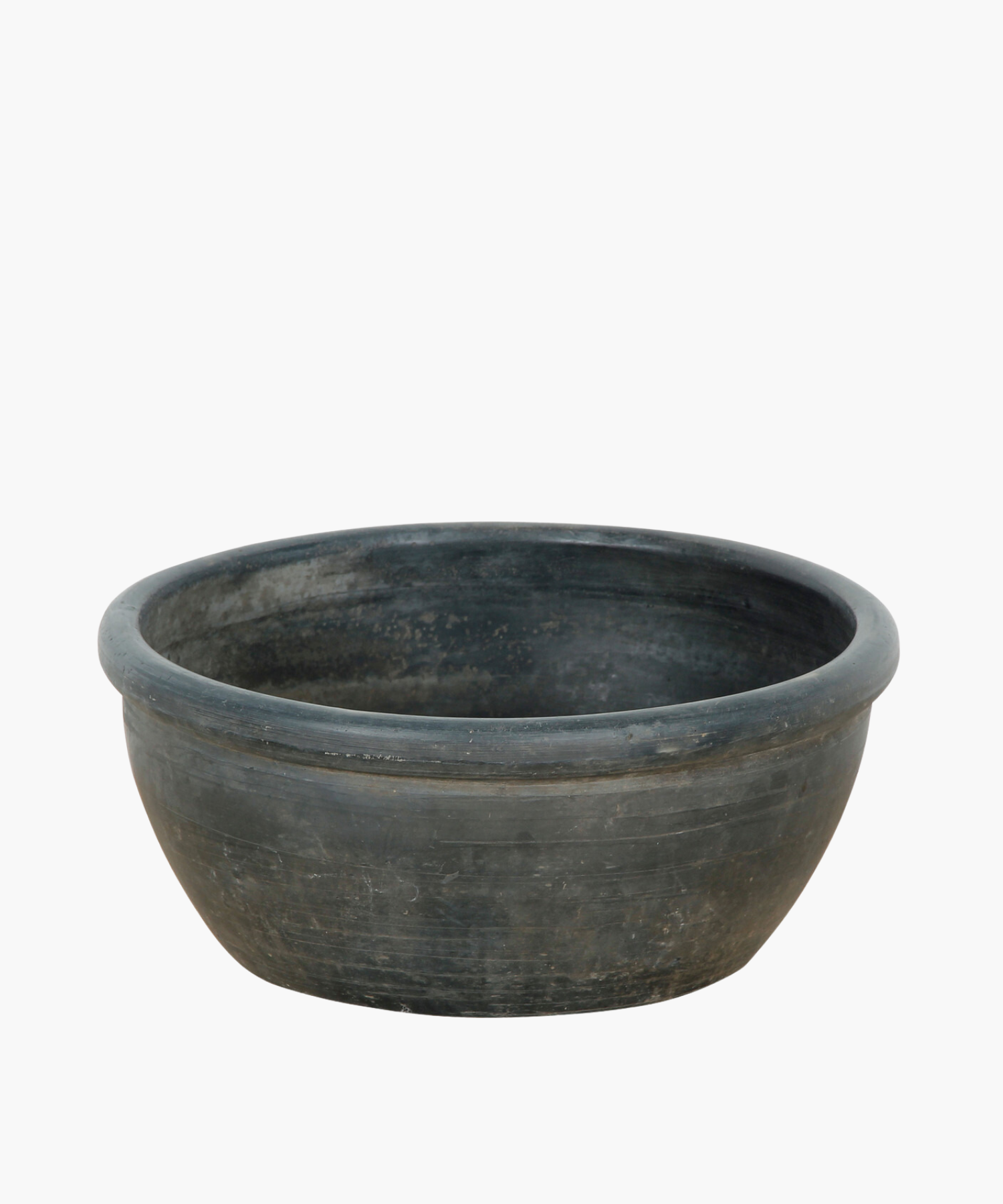 A large, shallow, grey black bowl with a smooth finish and subtle textures. The bowl conveys a rustic feel.