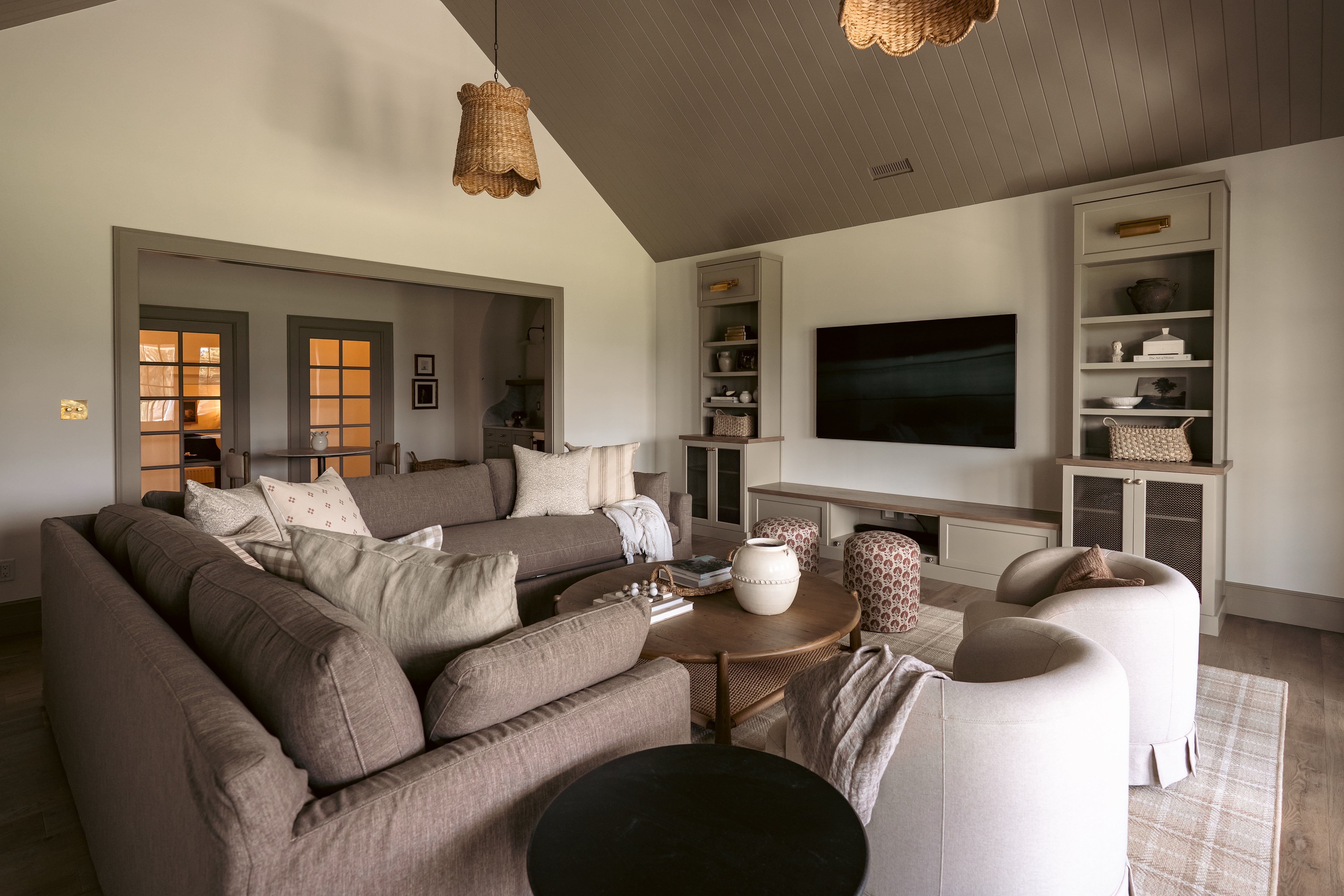 Modern living room with gray sofa, TV, and decorative items.