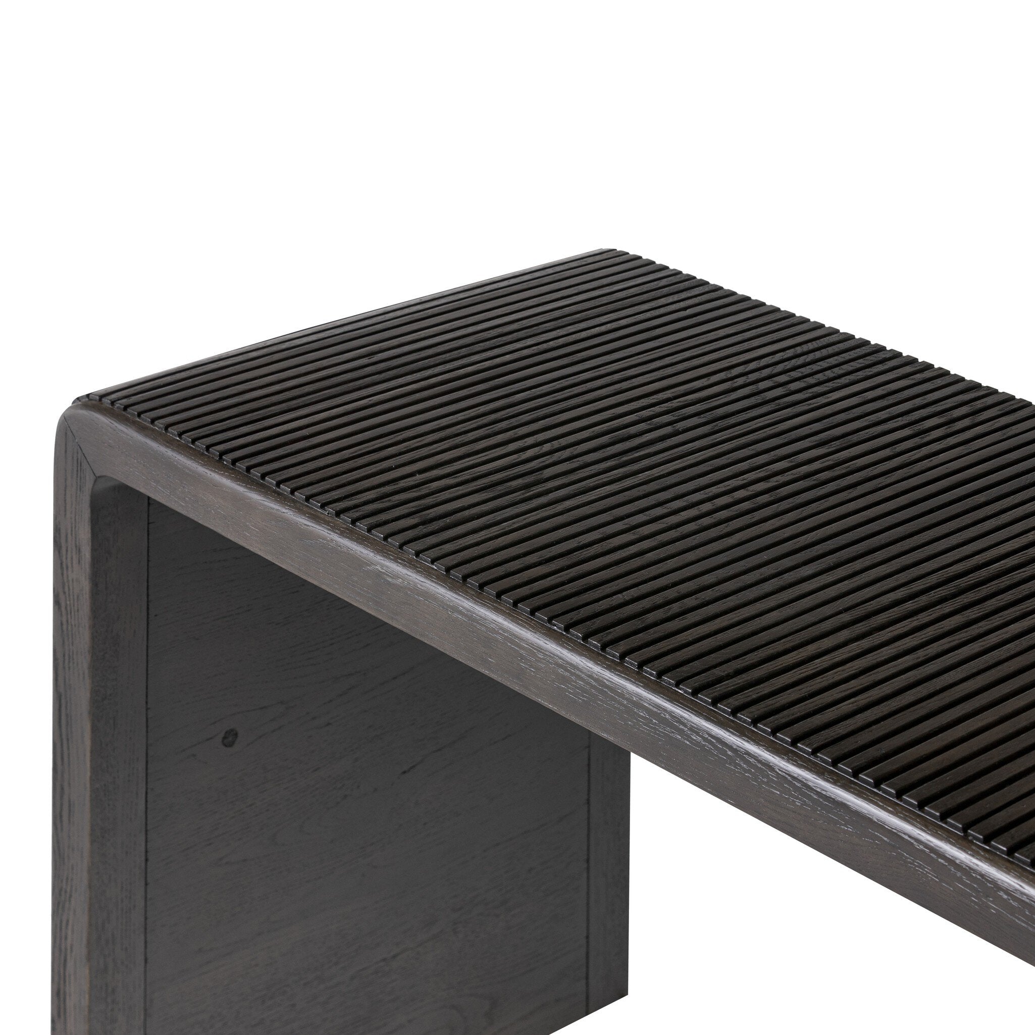 Smoked black oak console table with reeding and rounded edges on a white background.