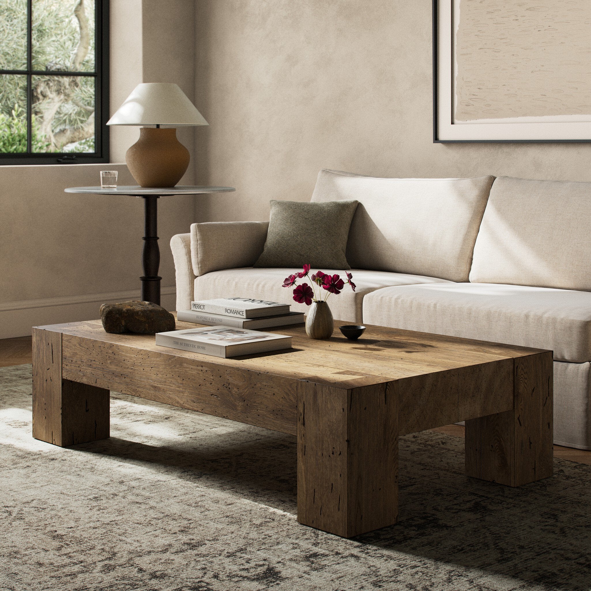 Living room with a wooden coffee table, beige sofa, and decorative items.